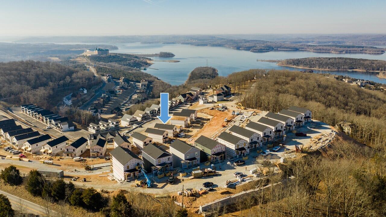New construction located in the new Chateau Mountain North Complex with a blow-out view of Table Rock Lake. This complex has been approved by Taney County to be used as Nightly Vacation Rentals, so whether you're looking for a great investment, or your own personal getaway, this is the perfect place for you. This 6B (with one being a bunk room) 5.5 bath property is being sold furnished, decorated and nightly vacation rental ready with a management company already in place! Seller's upgraded to a full patio & deck, added stone all the way up on the fireplace and added a covered upper deck.  It will have a 1 year Builder Warranty when complete. COA dues include water/sewer. It's conveniently located to downtown Branson for plenty of entertainment, shopping and dining; and Silver Dollar City is only 10 minutes away!  (Finished photos are of a similar property) (Amenity photos are from Chateau Mtn. across Gunner Hill but will be similar). Property taxes are only on the lot as build hasn't been assessed yet.