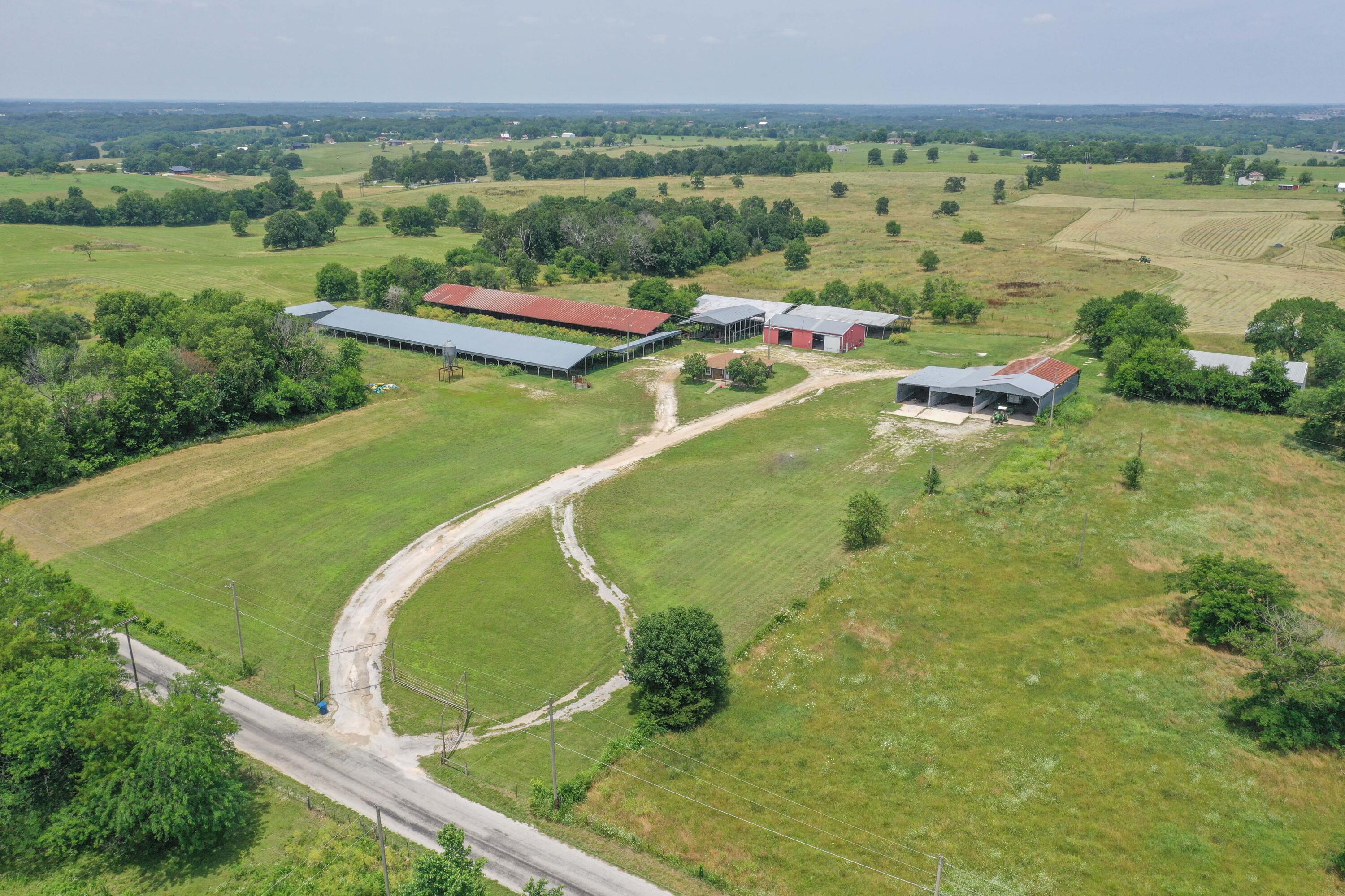 Cattle Ranch, Development Potential, Great Location in Ozark, Missouri!  Country living close to town!  Farm includes a large shop, multiple barns, and outbuildings are only a short walk from the home. There are additional barns and a working area on the north side of the farm as well. Perimeter and cross fenced, this property is set up for cattle with 4 winter proof waterers, feeders and a hydraulic chute. Also included are two billboards with Highway 65 visibility for additional revenue!This property also features a charming 2-bedroom, 1 bathroom bungalow farmhouse was remodeled in 2020.Conveniently located only 4 miles from shops, restaurants, and grocery stores in Ozark and a quick 15-20 mile drive to Branson or Springfield.This beautiful piece of property is already surveyed into 5 lots ranging from 20 - 36 acres each and is the perfect place to start your Southwest Missouri farm life or build your dream home!Additional purchase options - Will Divide - call for more information!
