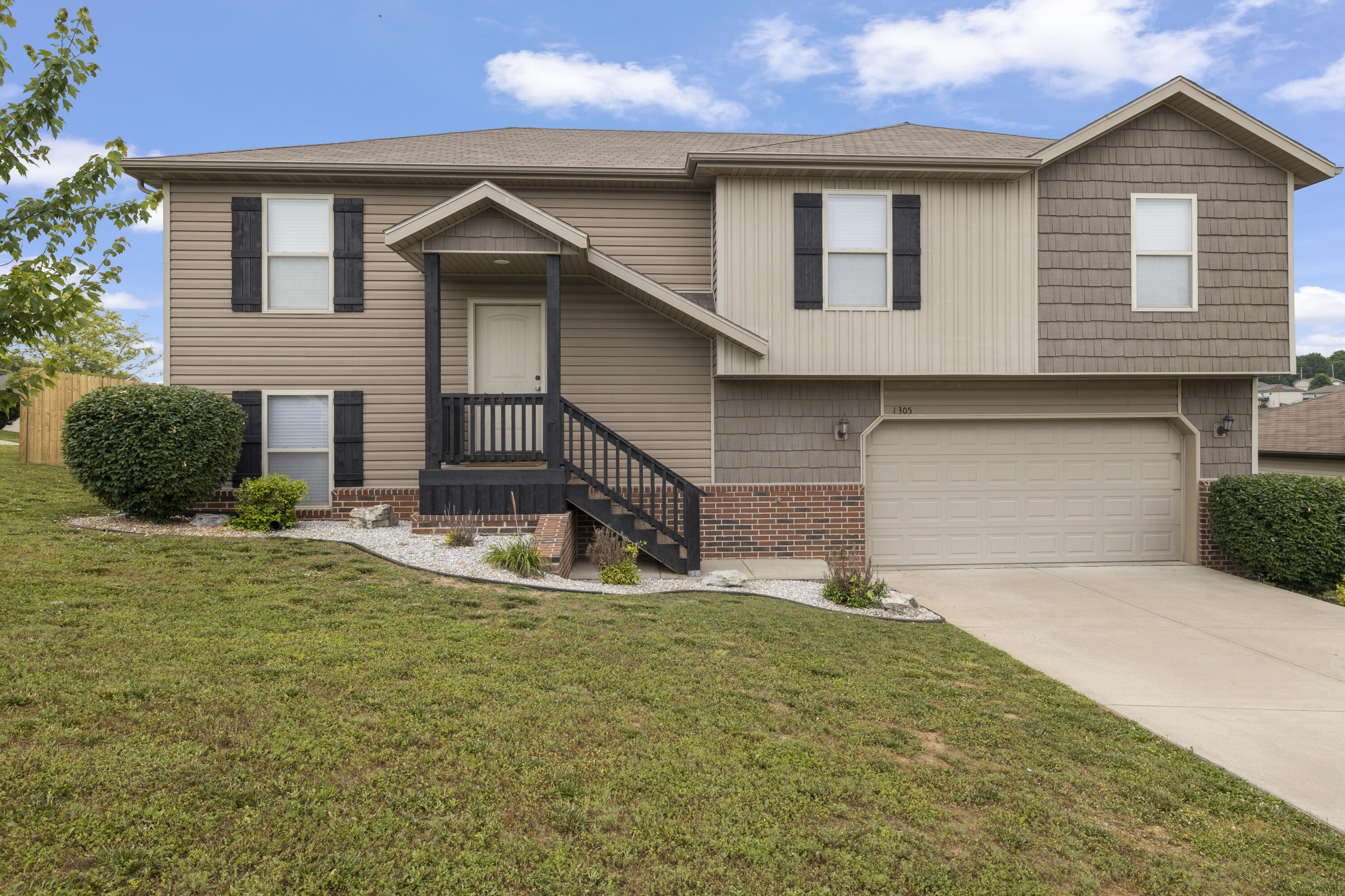 If you're looking for a spacious split level home, this is it! This one-owner house has been very well taken care of and has had lots of recent updates!  The main living area boasts a cozy living space with neutral colors, a new electric fireplace with stone and shiplap, and brand new engineered hardwood floors.  Wide baseboard trim and recently added beam-work are sure to be noticed by all who enter.  The dining room has a newly added accent wall and room for a large dining room table.  The kitchen has plenty of space in the dark wood cabinets.  Conveniently located off of the kitchen is a large laundry room that doubles as a pantry!  The main level includes 3 bedrooms and 2 bathrooms, including the master suite which boasts a dual sink vanity and walk-in closet. In the basement you will find a large second living space and plenty of storage space. There is also a 4th bedroom and a third full bathroom, perfect for guests or older children!  Enjoy sitting on the back deck looking at the beautiful city of Ozark and watching kids and furry friends play in the fully fenced back yard. Call for your private tour today.