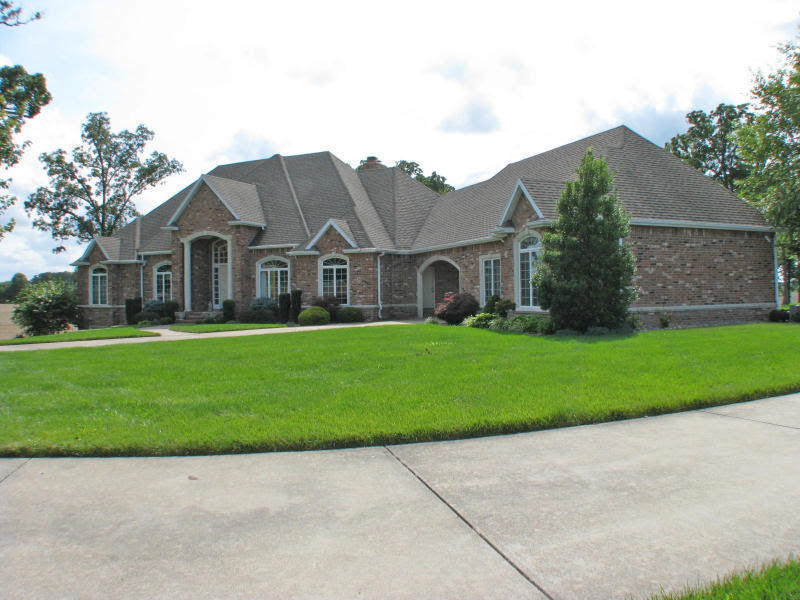 Minutes from Springfield, All Brick Home on 7 Gorgeous Ac (MORE LAND IS AVAILABLE!!) w/WO Bsmt, 2 Living Areas, Formal Dining, Office w/Built-ins, Covered/Screened-In Porch offers relaxing view of the neighboring Acreage, 2 Fireplaces, Security System, & Rec Rm w/Kitchenette. Main Kitchen w/ aplnc's & Pantry, Center Island & Bkfst Bar! Lrg Mstr Suite w/Luxurious Mstr Bath & Jetted Tub! Large Windows show the Beautiful Scenery property sits on. HVAC system has built-in humidifier. Separate Central Vac in Garage. Some Furnishings available,  White vinyl fence borders both sides of concrete drive with gorgeous and mature Landscaping throughout.