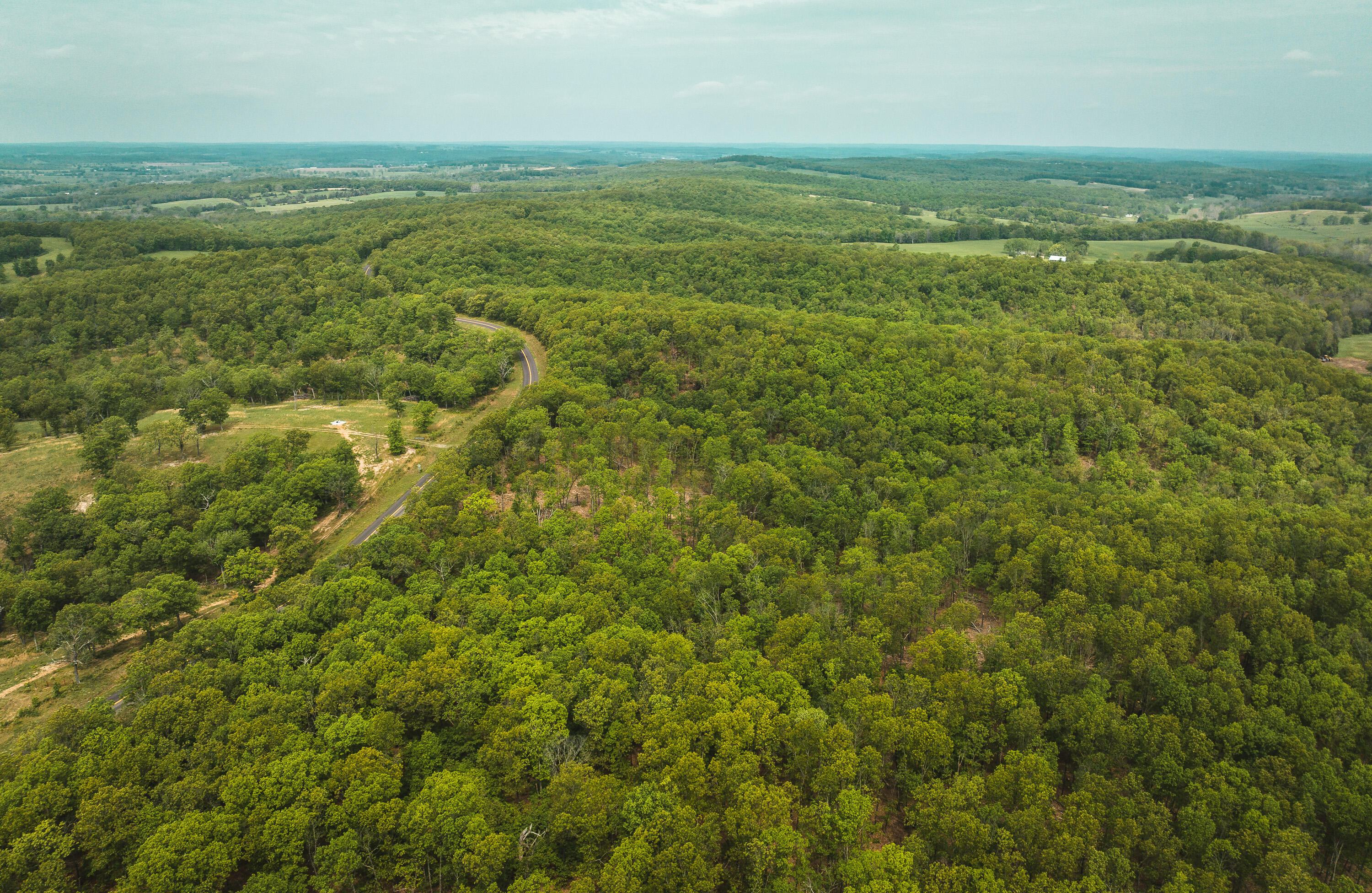 20 m/l acres in Elk Creek, Missouri located off State Highway H providing highway frontage. This property has timbered valleys with excellent ridge tops for tree stand locations and an unbelievable population of whitetail and turkey.