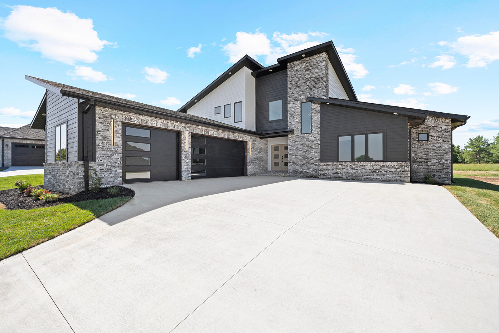 This home is a jaw dropper with it's gorgeous modern architecture. This quality Third Day Built home's main level boasts over 2000 sq ft of living space in an open concept floor plan. There is a huge living space with a 2 story ceiling showcasing big windows great for natural sunlight.  A beautiful fireplace with a custom metal mantle will be the focal point of the entertaining space. Open to the baker's dream kitchen is a large eat in space with room for an oversized dining table. There is a large center island with waterfall quartz, custom floor to ceiling cabinets, stainless steel appliances (including a double oven), a separate coffee bar and access to a nice covered patio that currently looks out to a field.  The main level includes the large laundry room, a walk-in pantry with room for all of your bulky kitchen gadgets, a guest bedroom with walk in closet and a common  bathroom. The main floor also includes a dream master suite with large bedroom, walk-in closet, dual sink vanity and an impressive tile shower with 2 shower heads and a free standing tub in the shower! Upstairs you will find nearly 1000 sq ft of space with 2 generously sized bedrooms joined by a jack and jill bathroom. There is also a sitting area with balcony overlooking the living room below. This home is in one of Ozark's newest communities that will have amenities including a neighborhood pool, pavilion, pickleball and basketball courts! This home is definitely one of a kind and sure to impress. Move in ready! Call for your private showing today!