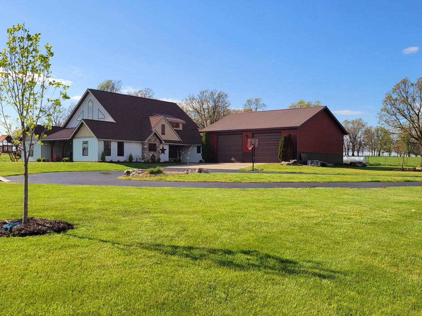 Rare opportunity to own a farmhouse style home AND a successful venue business on almost 40 acres! Drive up to this alluring home on a smooth, asphalt driveway. Home has a large living room with an open concept floor plan. Living room features an over-sized farmhouse fan and 30 ft. peaked ceilings. There are also heated floors and a 6,700 BTU pellet stove to keep you warm. Kitchen has generous storage space, a full pantry, custom cabinets, granite countertops, upscale appliances, and a deep farmhouse sink. The island boasts a mini fridge, perfect for storing drinks/snacks. The dining area is open and BRIGHT with plenty of room to host guests. The home has 4 bedrooms, as well as 4 bathrooms. Doorways are all 3 ft. wide and wheelchair accessible. The Master bedroom is a large size, and the closet is what dreams are made of. Master bathroom has custom cabinets, with double sinks, plenty of storage, and a relaxing oversized tub. The upstairs can be used as a bedroom or as a play area. There are 3 large closets upstairs and a full bathroom. This home has 2 HVAC units with 90% efficiency and a HEPPA filtration system to improve the air quality. A mudroom on the main floor is an added bonus and makes a fantastic transition space. The attached 2 car garage measures 40X40 and has upstairs attic storage. Outside there are almost 20 acres of pasture, and a covered front and back porch will allow you to enjoy the tranquil scenery all year long.The venue is almost 6,000 sq. ft., booming business and shows growth each year. This building contains a full kitchen, a bridal suite, a groom suite (each with their own bathrooms), indoor and outdoor restrooms (1 full bathroom, & 4 half), an entertainment area upstairs, and a full, open area for weddings/receptions. Building is heated and cooled by 2 HVAC units and 2 mini split units. Venue Outside, there is an outdoor ceremony area, and a fire pit, perfect for warm summer nights. Owner is agent.
