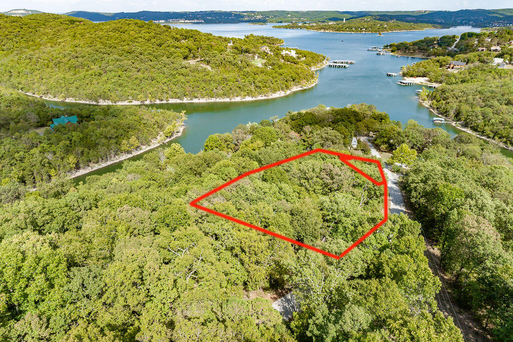 Land ho! Nestled in the Ozark hills, this vacant land parcel consists of five combined lots overlooking beautiful Table Rock Lake. Whether looking for a place to build your own private estate, or individual lots to build new construction homes, this vacant piece of ground offers easy road access, plus electric and community water available. A convenient location too! In addition to being near several area landmarks such as Big Cedar Lodge, Top of the Rock, and Dogwood Canyon, the Blue Eye School District is just a short drive away making Glen Oaks a great place to call home. Large acreage opportunities like this one on Table Rock Lake are fading quick! Come for a walk of it.