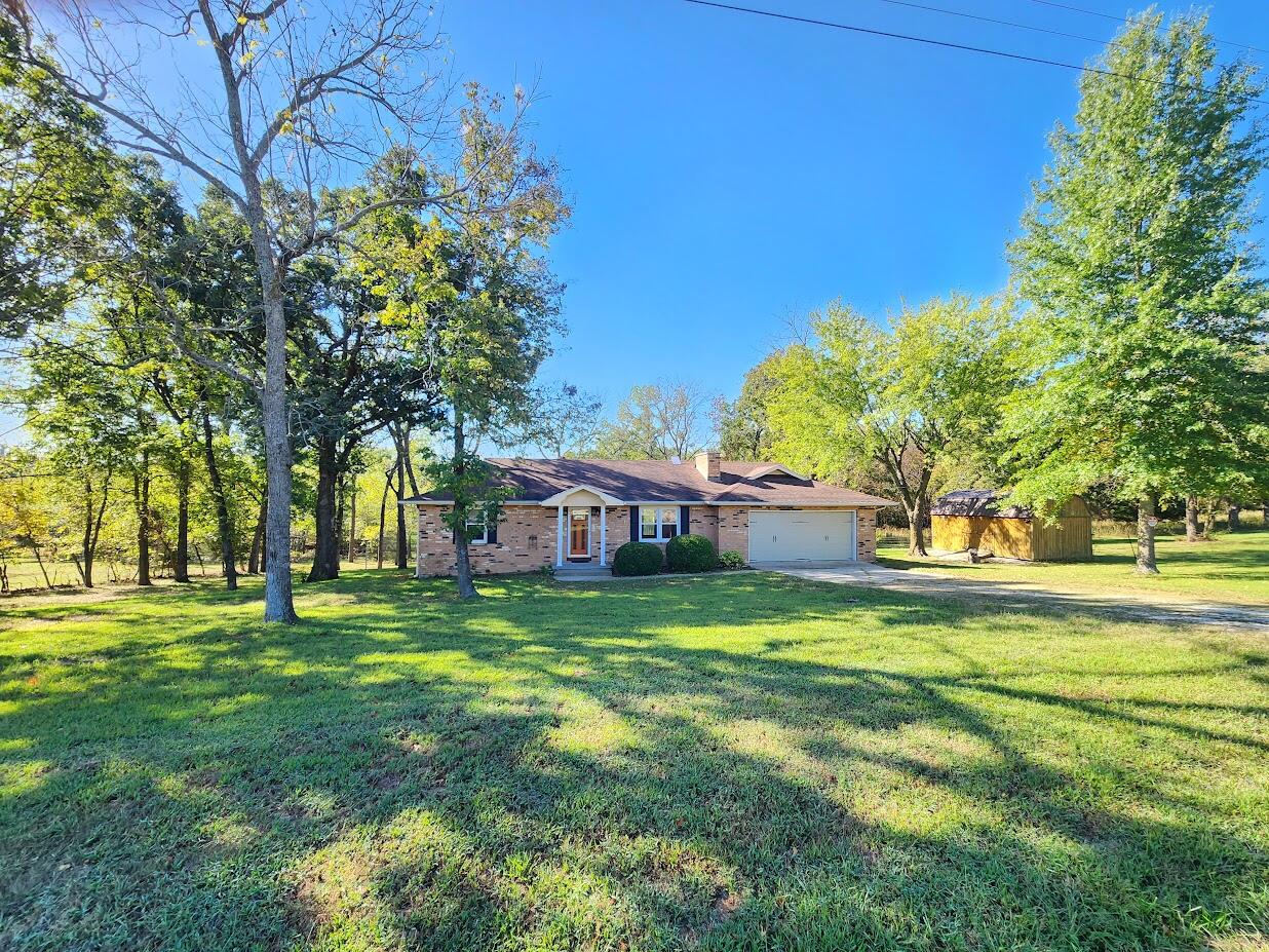 Discover this inviting 3-bedroom, 2-bathroom home just 2.5 miles from Memorial Park and minutes from Bolivar High School, CMH, and the tech school. Enjoy main-level living with a cozy wood-burning fireplace, a 2-car garage with dual entry points, and a deck overlooking nearly 1 acre of serene land filled with nature and wildlife. The brick exterior features colonial-style accents, complemented by two sheds and a quant creek behind the property. Perfect for those seeking a peaceful retreat close to town!