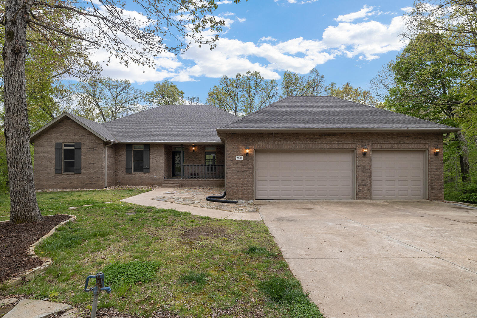 This fantastic all brick walkout basement home in Nixa schools is on 3 acres in the beautiful Pebble Creek subdivision. The first floor was renovated/updated in 2022, the home is in great condition and is move-in ready. The layout was redesigned to offer a popular open concept design for the dining room, living room and kitchen.  The view of the woods is gorgeous, with deer and turkeys making regular appearances. The kitchen has all new cabinetry, GE Profile appliances, quartz and granite countertops, a full height backsplash and a pot filler. The new island is massive and the refrigerator stays. The laundry room, mudroom and pantry area was also redesigned for maximum convenience. The master ensuite boasts a master bathroom that was gutted and redesigned with a huge soaking tub and the closet has a custom closet system. There are also two more bedrooms and another full bath upstairs, the second bath was also completely redone. New engineered hardwood and fresh paint throughout offers a modern and clean feel. The basement has a large family room with a wet bar, an office, two more bedrooms, a full bath, additional space for storage and a man cave.  The gun safe stays. The roof was replaced in 2020. The deck was replaced and the fence installed in 2022. There is a gas powered generator wired into the home. The HVAC system is geothermal/ground source which is very efficient, the electric bill averages $136. There is also a water softener, water filtration and UV light purification system. This beautiful home has a lot to offer, come check it out today!