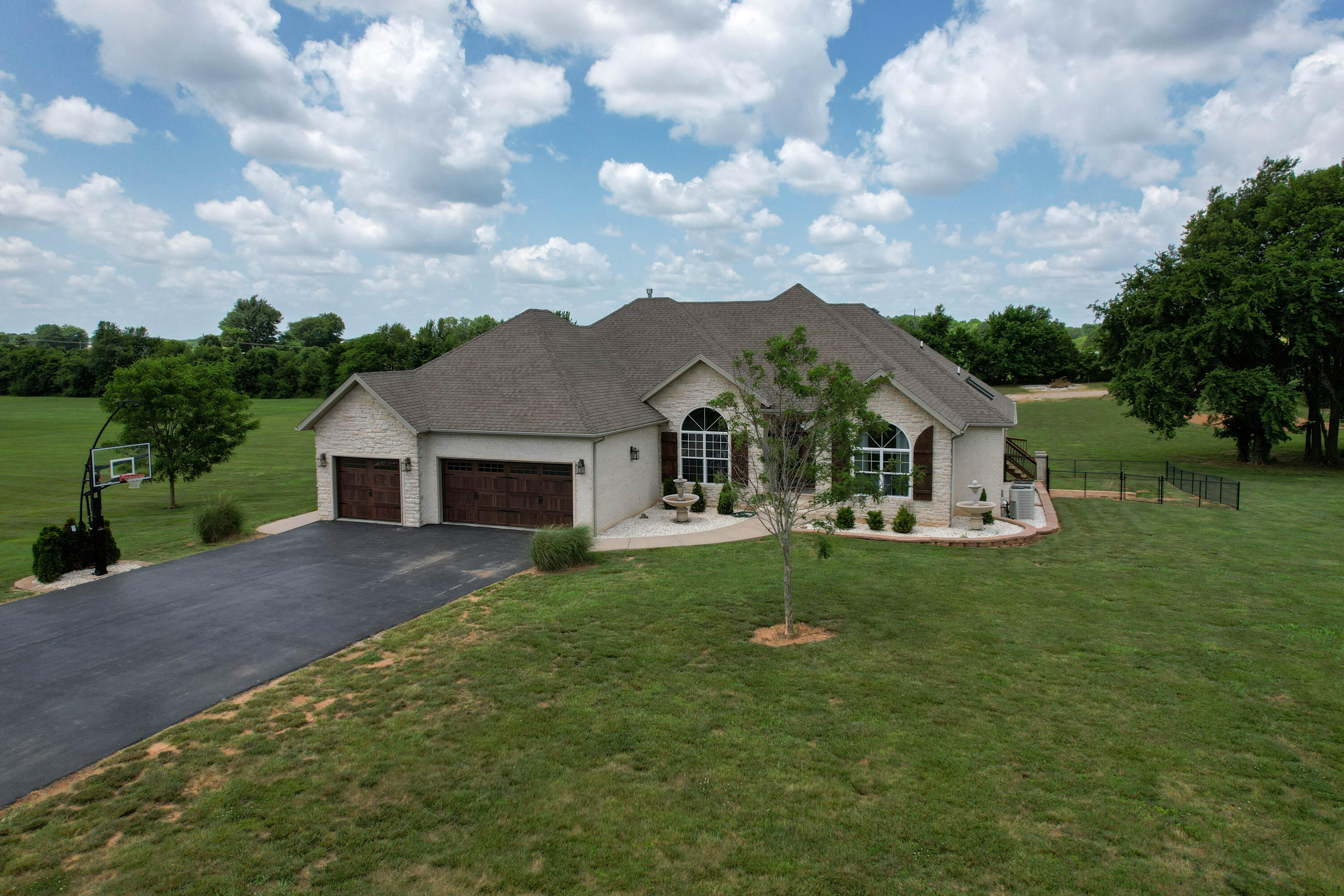 Sitting on 5+ acres with panoramic views, this ALL BRICK and STONE beauty has so much to offer! Recently remodeled 2019, the home has new LVP flooring, carpet, stair banisters/railing, light fixtures, paint, windows, appliances, garage doors, shutters, front doors, and completely updated kitchen! A generator was recently installed, which could come in handy with our Midwest weather! A bedroom was added downstairs and it's huge (24.8x13)! This room addition brings the total room count 5 BRs (3 upstairs/2 downstairs). Have I mentioned the bathrooms... there's SIX total bathrooms! Upstairs you'll also find a nice-sized formal dining with great natural light. The main bedroom has an en-suite bath with jetted tub, walk-in shower, and skylight. Venture downstairs and you'll find the other 2 BDs, 2BAs , 2nd living area with a great stone fireplace, wet bar (it lights up!), and storm shelter/storage. Outdoors is just as incredible with a covered back deck and covered patio- both areas are great for entertaining and enjoying the country air! On the far end of the property is a large shop (30x50) with water, electric, heat, and a powered garage door. Located on a quiet street and just a short distance to Springfield. What doesn't this home have!