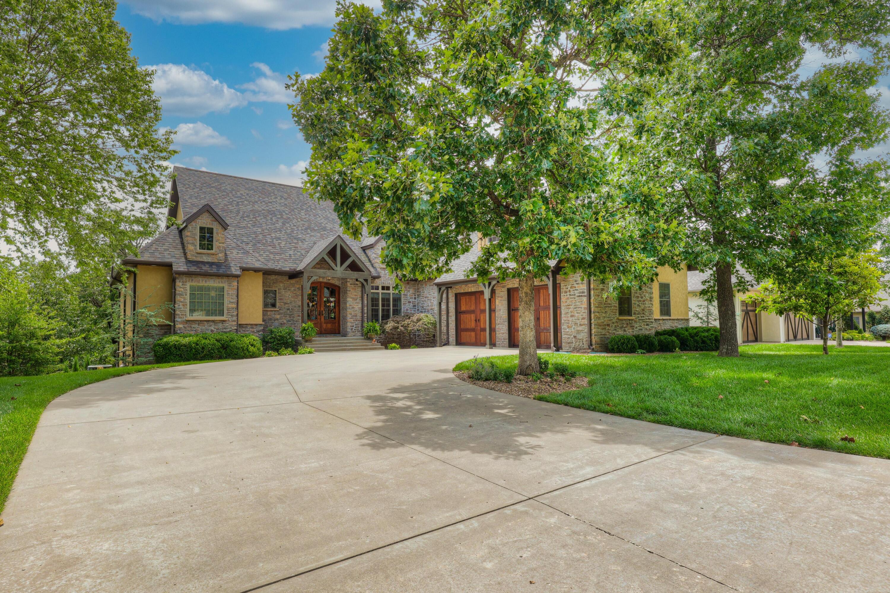 Just in time for summer and turn key ready! Imagine your friends and family around the NEW infinity pool w/hot tub. Feel right at home the moment you walk through the front doors of this home! Upon entering the living room, a gorgeous stone fireplace makes it the perfect place to relax. The cathedral ceiling with wood beams and solid hardwood floors add timeless character. Right off the kitchen, you can enjoy the oversized covered deck with sun shade. Perfect spot for your morning coffee.    Be sure not to miss the magical bonus room above the garage.  Walkout basement with full kitchen, bedroom and bathroom with tons of storage, John Deere garage and additional pool supply storage room.   Your dream home awaits!