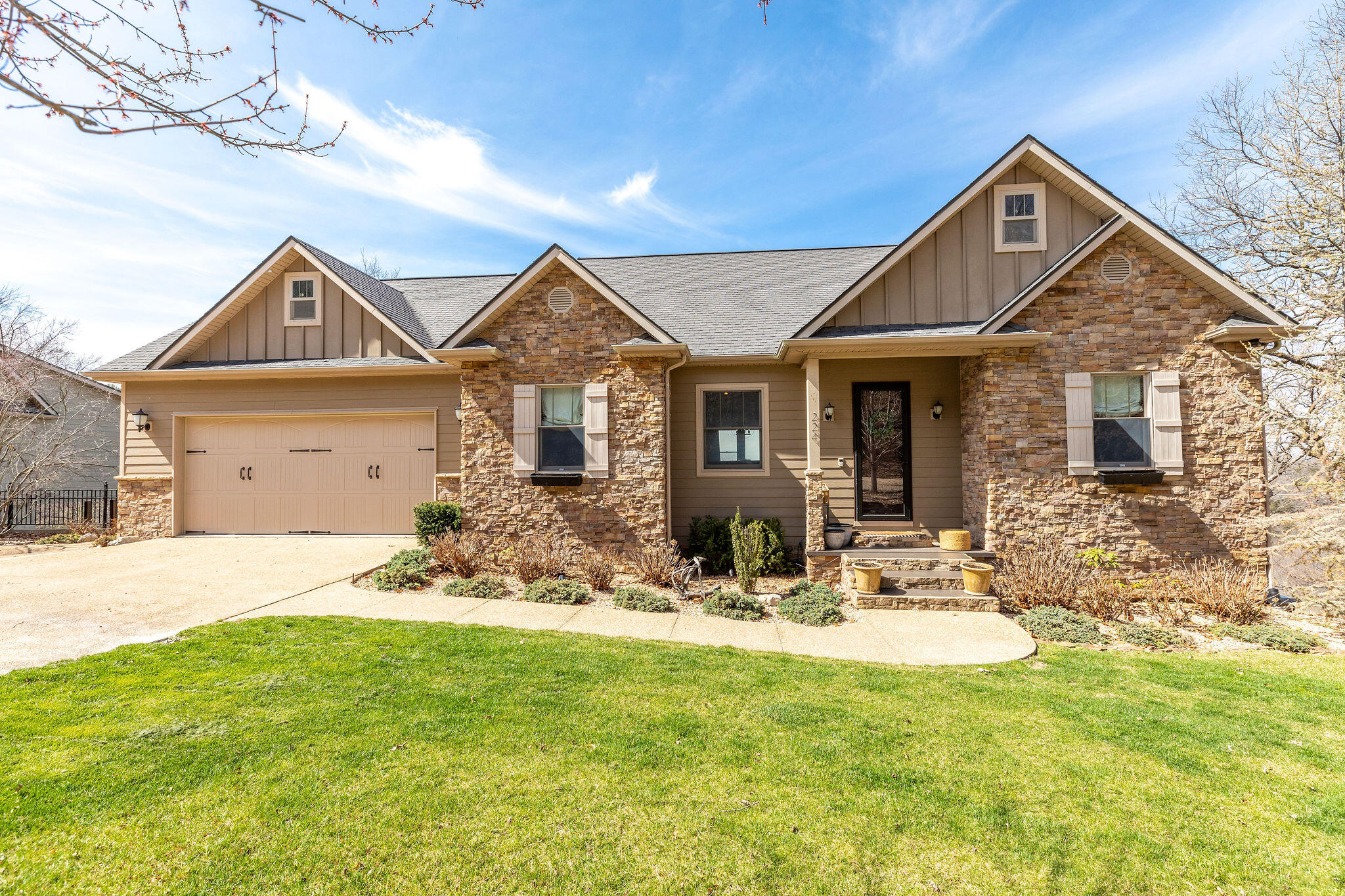 Dream home! Lake views! Boat slip & boat available! This gorgeous cottage style home is the epitome of comfort and style. Luxurious while still homey. Beautiful setting and a wonderful lake view! A total of 3957 sqft, 3 bedrooms, and 2.5 baths on two levels. Every room is picture perfect! Beautiful high quality finish work throughout the home. Awesome lower level rec room perfect for entertaining family and friends! There's a Hot Tub Too! In demand location on the lake yet conveniently close to Branson, Hollister & less than 5 minutes from Big Cedar. Community amenities including an indoor pool! 10 x 28 leased boat slip transferrable with optional purchase of 27' 1999 Cobalt, model 272 with Bow Rider & Volvo in-board motor & lift available for $30,000. This home is definitely best in class!