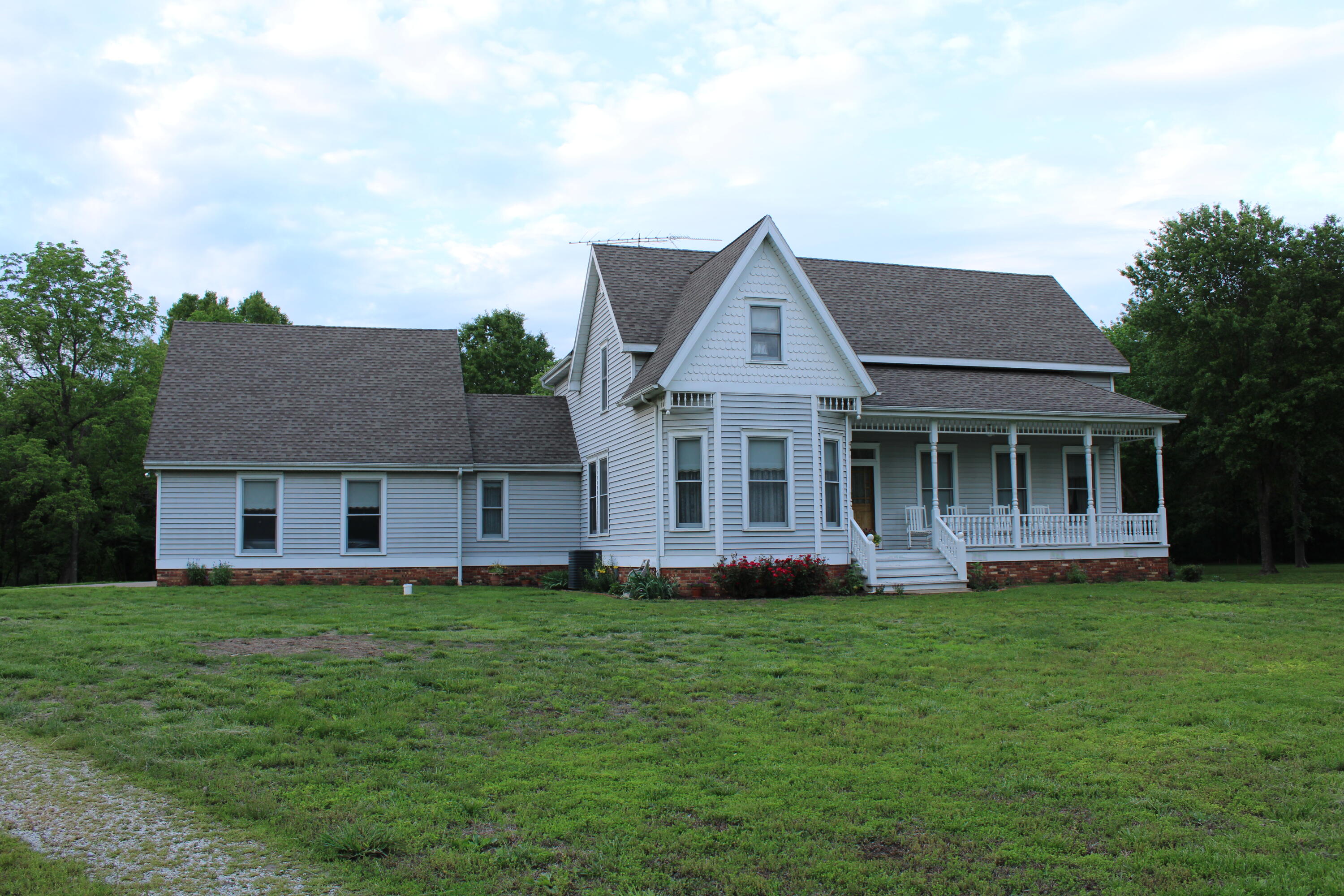 Welcome home to this beautiful four-bedroom, four-and-a-half-bath Victorian-style home. It is nestled on 53 acres of pristine land, with abundant wildlife and in close proximity to several lakes. This setting is perfect for those who enjoy nature and outdoor activities. The Victorian architecture adds a touch of timeless elegance to the home, while the full unfinished basement offers added space and potential for various uses. The home boasts two living areas, a large main suite with a walk-in closet and luxurious jetted tub. There is a half bath off the large 2 car attached garage You will find ample space upstairs with three bedrooms and two baths, a large landing and plenty of storage. You can enjoy the serenity of your surroundings on the front covered porch or the screened- in back porch. You will also enjoy a beautiful and functional approximately 30 by 40 Morton Building with Leaf Guard gutters. The property sits on black top and is in the Osceola School District. It is an hour north of Springfield, 32 miles north of Bolivar and 28 miles south of Clinton. All offer excellent medical and shopping facilities. This property is a nature lover's paradise. With a mix of lush timberland and open spaces, and two ponds. This tract offers a diverse landscape that is a haven for wildlife which makes it a prime location for hunting and wildlife observation. The property's proximity to Stockton, Truman, and Pomme De Terre lakes and Lake of the Ozarks adds to its allure, offering easy access to water activities and scenic views. Whether you are an outdoor enthusiast or looking for a peaceful retreat, this property has something for everyone. Imagine waking up to the sounds of nature and having the opportunity to enjoy nature in its finest.  This home could be a beautiful bed and breakfast, a hobby farm, as well as an amazing place to raise a family. The area offers excellent schools, a small town feel but close to superb medical and shopping facilities.