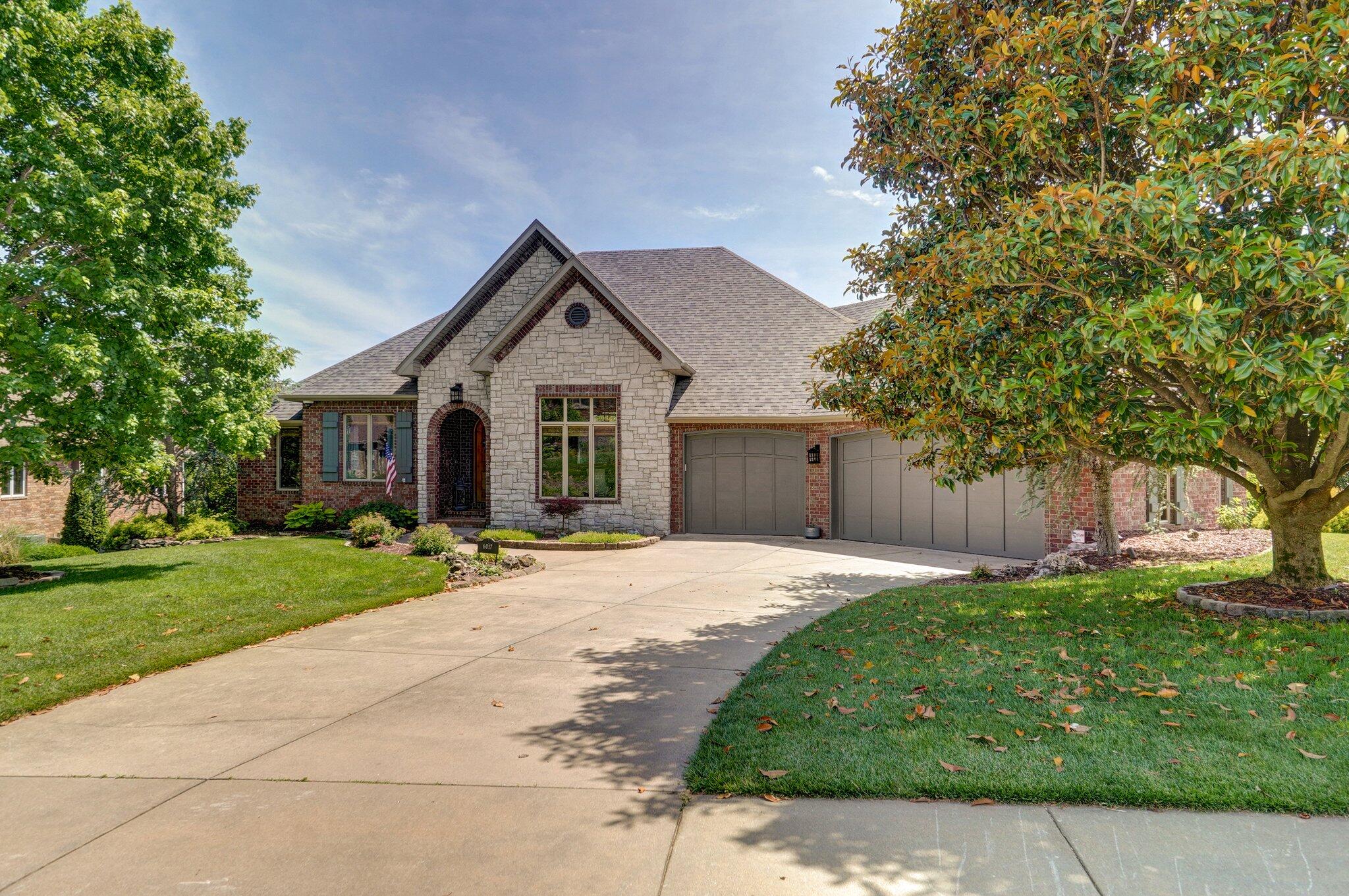 Step into the exquisite world of this Rivercut Golf Community gem, where every glance offers breathtaking views of the 18th fairway and serene lake. Recently renovated in 2020, this home is a testament to elegance and craftsmanship. As you step inside, you're greeted by a seamless flow from the formal dining and living rooms to the spacious kitchen, dining area, and hearth room, all illuminated by natural light and accentuated by high ceilings. The heart of this home, the kitchen, boasts custom cabinetry, a gas cooktop, double wall ovens, stylish fixtures, ice maker and stunning quartz countertops. Entertaining is effortless, whether you're hosting guests in the light-filled interiors or on the expansive covered deck, a tranquil retreat for any occasion. The main level features a luxurious primary bedroom with raised ceilings, offering a rustic farmhouse ambiance, complemented by an ensuite featuring a tiled shower, dual vanities, and a well-appointed walk-in closet. Additional highlights include another ensuite bedroom ideal for guests or a home office. Downstairs you will find a comfortable family room with a wet bar and two more sizable bedrooms with a full bath. A cozy space is tucked away that can be a playroom, media room or another option for your home office. There is ample space for customization in the 700 sqft John Deere room. The three-car garage provides ample storage, with room for a truck and two cars (or even a boat). From the meticulously landscaped exterior to the thoughtfully designed interiors, this home epitomizes comfort, luxury, and quality at every turn. Experience the epitome of refined living in this brick and stone sanctuary, where indoor-outdoor living seamlessly intertwines, inviting you to create unforgettable memories in your own private oasis.