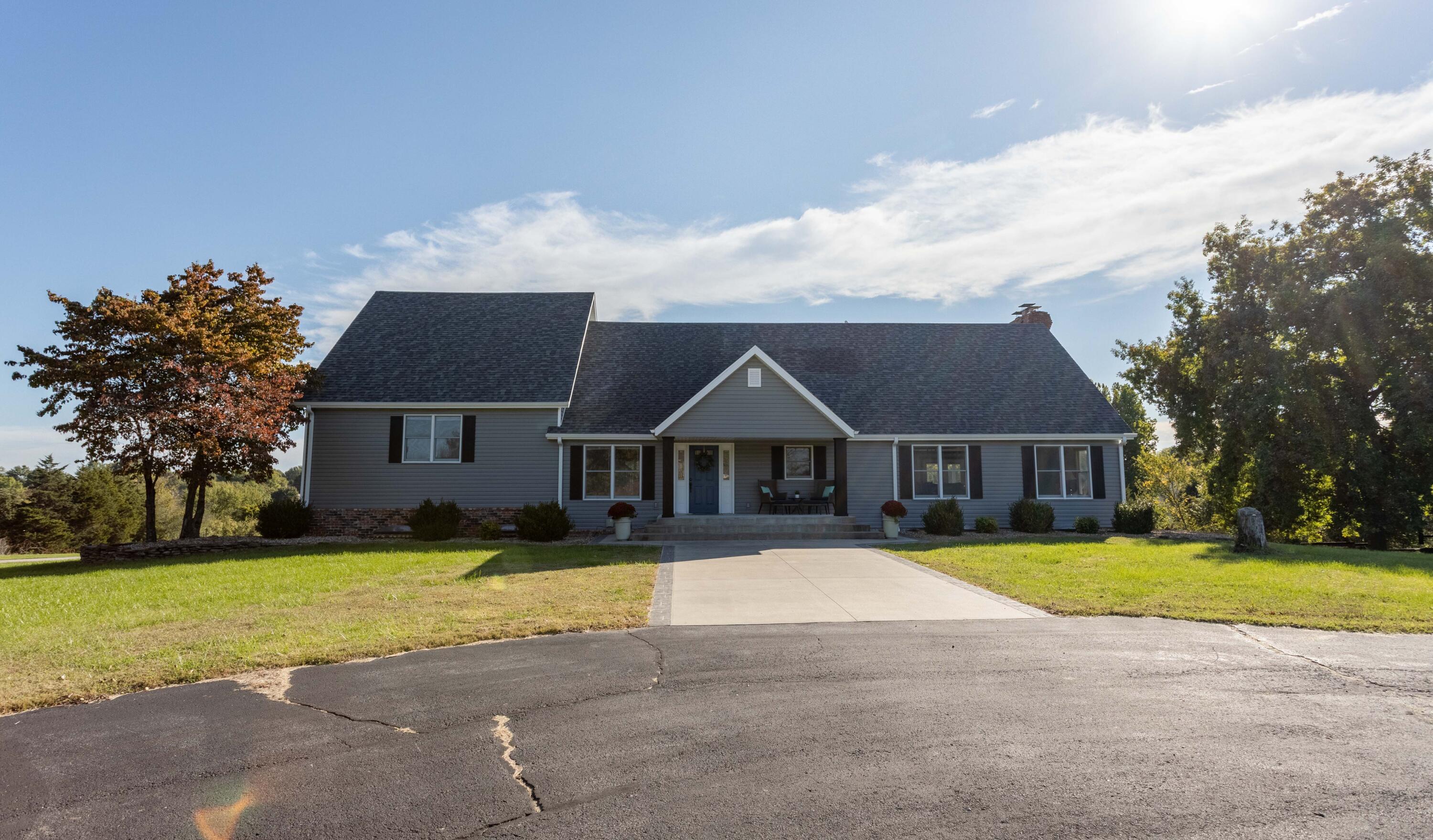 This is a diamond of a value! 2 parcels that total 6.94 acres out of city limits. New Roof, Gutters, Downspouts, Shutters, & Siding all in 2021! Beautiful woodwork and crown molding trim out this spacious home. 2 Living areas- one on main level and another in the basement level (both have a wood burning fireplace) Granite counters in most of the home, and as an additional bonus, the downstairs also has a wet bar/ kitchen area! If you have kids, check out the 3 schools here. Speaking of kids, the outside play area stays as well. If you enjoy a sun room- no problem! We have that too. If you enjoy entertaining, in addition to the sun room there is a very large covered and uncovered decking, which can host a rather large crowd.  Down the hill from the house is s natural spring. This home has much to offer and gives you room for the extras you may want to enjoy. Set up your showing today.