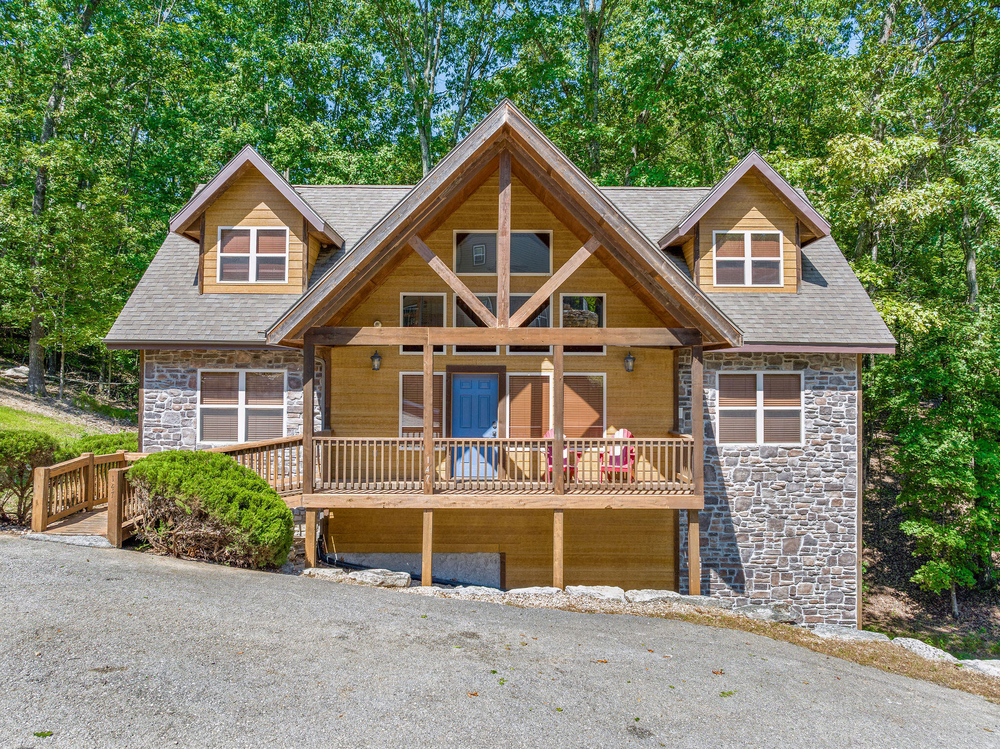 Turn key income producing vacation rental lodge on highly sought after Indian Point! Situated very close to Silver Dollar City, Table Rock Lake and all Branson has to offer, this spacious home is an excellent place to vacation with multiple families where everyone can spread out after a day of sight seeing. The amenities at Crown View include an outdoor pool with a slide, a play area and coming soon an indoor pool! Each large bedroom has an en suite bathroom. There are 2 bedrooms on each level (2 stories with walk out basement) 2 fireplaces and 2 decks. There is plenty of room for entertaining and even a pool table! Updated paint color and LVP flooring. This home is situated so it offers more privacy than many others of its kind with there being woods on 2 sides. There is room for value add which is a great opportunity for equity. Seller is offering $6k towards new counters at closing.  There is also the opportunity for owner finance with an acceptable offer with at least 20% down. Call for more information!