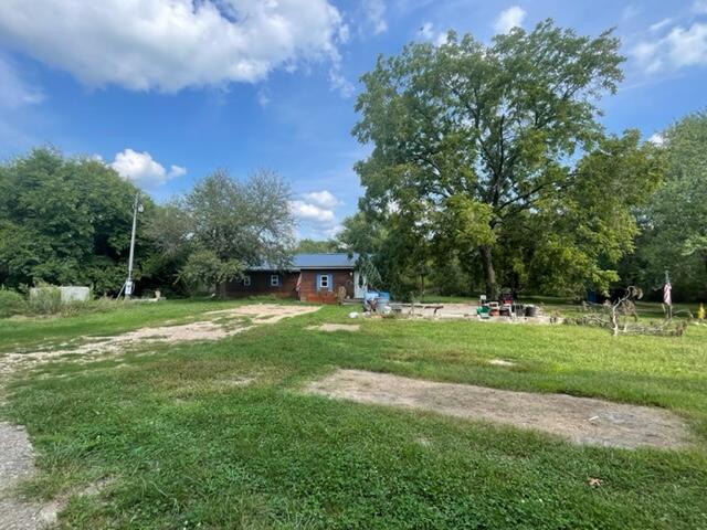 Great location short distance north of town and pavement ends at the driveway. On the corner of Girlstown Road and Willow Road with a 3 bed 2 bth house that needs some TLC . The house was built in 2015 but has never been finished, at that time there was a new septic and well pump installed. This was an old homesite so there is a root cellar and old barn on the property also. You will love the large oak tree as you turn in the drive and several other shade trees make the property have a beautiful setting whether you decide to finish the house or start over and build your dream home.