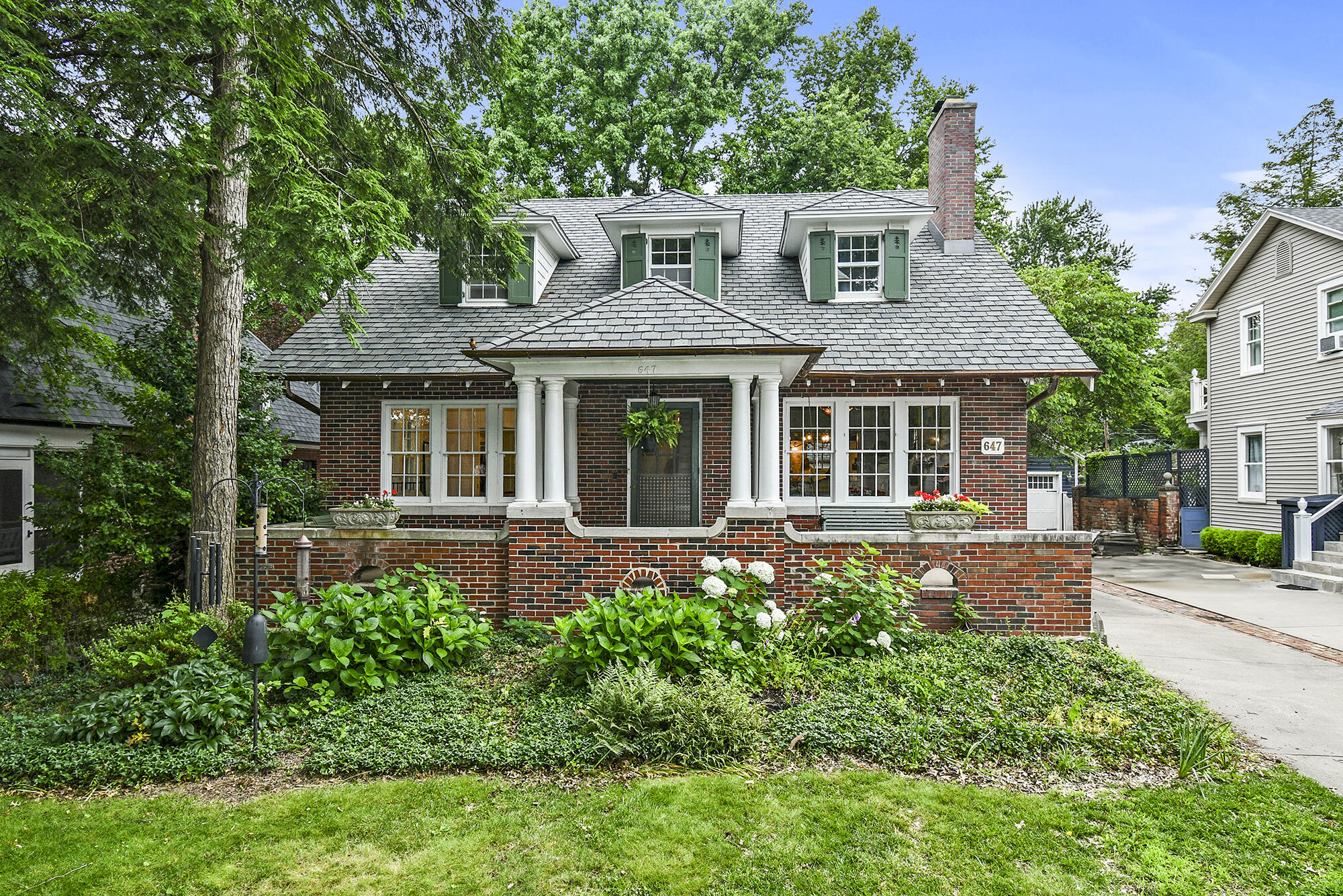 Step into a piece of history with this enchanting modern English cottage-style all-brick bungalow, where timeless elegance meets modern comfort. Charmingly remodeled, this 4-bdrm, 3 1/2bth home features finishes that reflect the original character of the home while meeting the needs of the modern family, preserving the treasures of the past. Nestled in the heart of Rountree's sought after Weller St, a picturesque neighborhood with mature trees and a lifestyle unmatched anywhere in Springfield.Original refinished hardwood floors throughout, intricate crown moldings, and vintage fixtures create an ambiance that is both warm and inviting. The generous floor plan includes a sun-drenched living room with a charming fireplace and a formal dining room providing ample space for relaxation and entertainment.This all opens up to the heart of this home, its well-appointed kitchen with the perfect blend of vintage charm and modern conveniences. The kitchen is equipped with a top-of-the-line, British-manufactured commercial-style AGA dual fuel convection oven and gas cooktop, along with a sister AGA refrigerator. The locally sourced walnut island and Phenix marble limestone countertops stylishly accent the handmade zellige tile full-wall backsplash, making the kitchen a culinary delight sure to inspire creativity.4 spacious bedrooms offer comfort and tranquility. The primary bedroom is complete with a private ensuite bathroom and laundry, double sinks, cast-iron clawfoot tub, and a walk-in closet, cle' tile, ensuring you feel pampered. Other features are a spacious family room in the basement and plenty of storage space.This classic residence is a perfect blend of old-world charm and contemporary conveniences, making it an ideal haven for families and history enthusiasts alike. Additional features include zoned heating and cooling purchased 2 years ago, a 3 yr old architectural roof, copper gutters, a wrought-iron fence,  storybook yard full of perennial treasures.