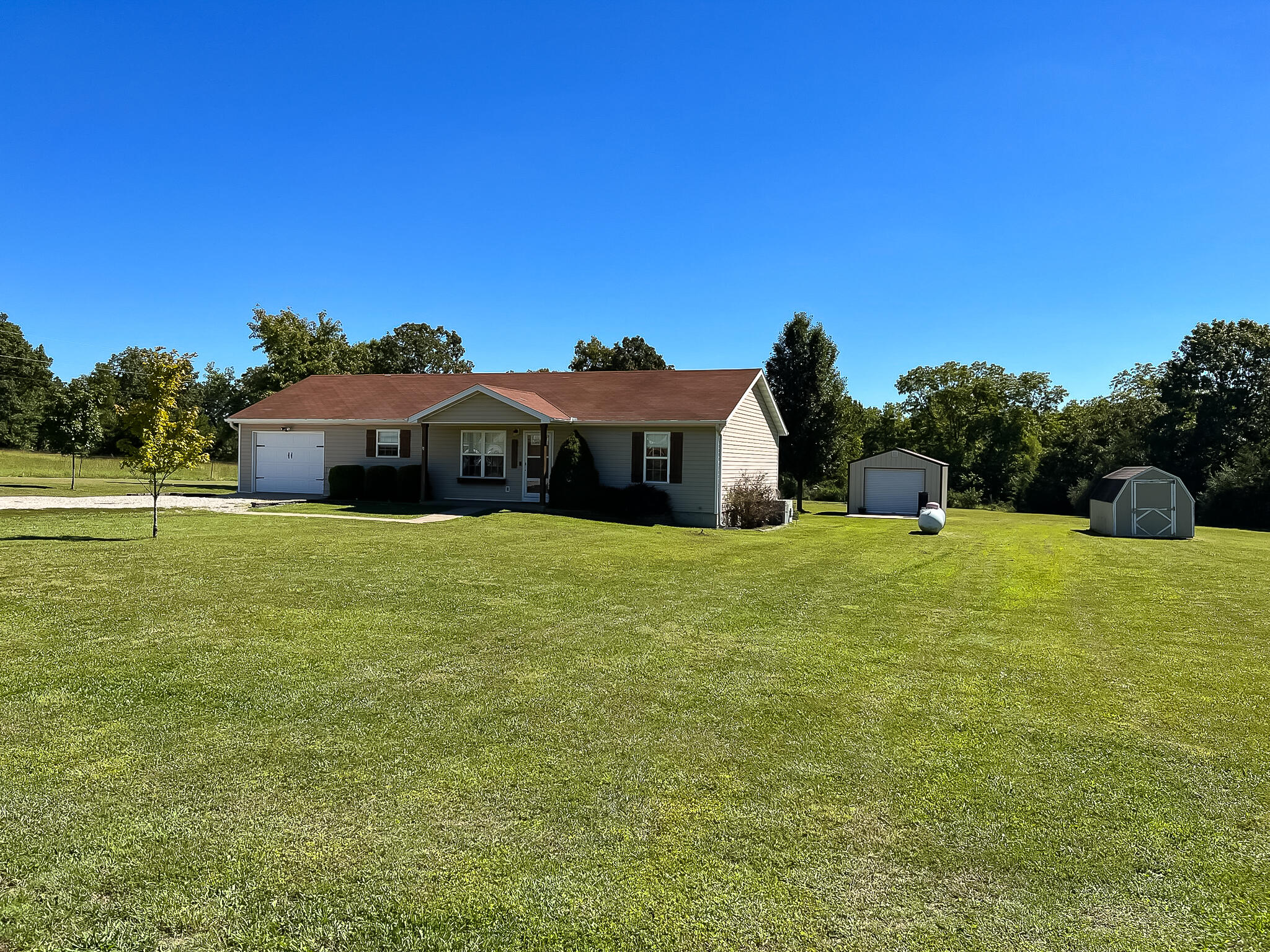 3 Bedroom, 2 Bath Ranch Style Home on 3.28 M/L Acres - Fantastic location on the outskirts of West Plains with shared neighborhood lake - Stunning Kitchen with Granite Counter tops and Pantry - Vinyl Tilt-In Windows - Entertainment Deck - Fire Pit - Perennial Landscaping and Fruit Trees - Workshop - Storage Building - Glenwood School District *Showings may begin September 11, 2023