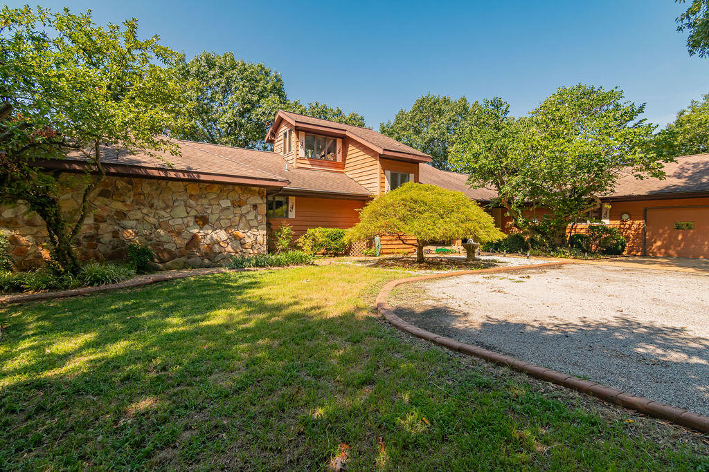 Hilltop Location with Panoramic Table Rock Lake views from estate style home on 41  platted lots equal to 10.53 acres with private paved driveway. The home features spacious rooms, soaring ceilings, natural stone fireplaces, walls of windows and a wrap around covered deck to enjoy the Ozark Beauty and Climate. Home has been well cared, and enjoyed by one owner since 2004. Original fixtures and decorative design, yet Open floorplan with main level living. The lower level is open with 40 x 22 great room with Wetbar, Atrium and More. Two guests rooms with Jack and Jill bath. Storage and multiple utility rooms. Minimal landscaping with a preserved natural setting allowing for mature trees and level yard. If you are looking for a home or a development, this is a rare opportunity. Don't hesitate to view this property. Note the photos and drone  view.