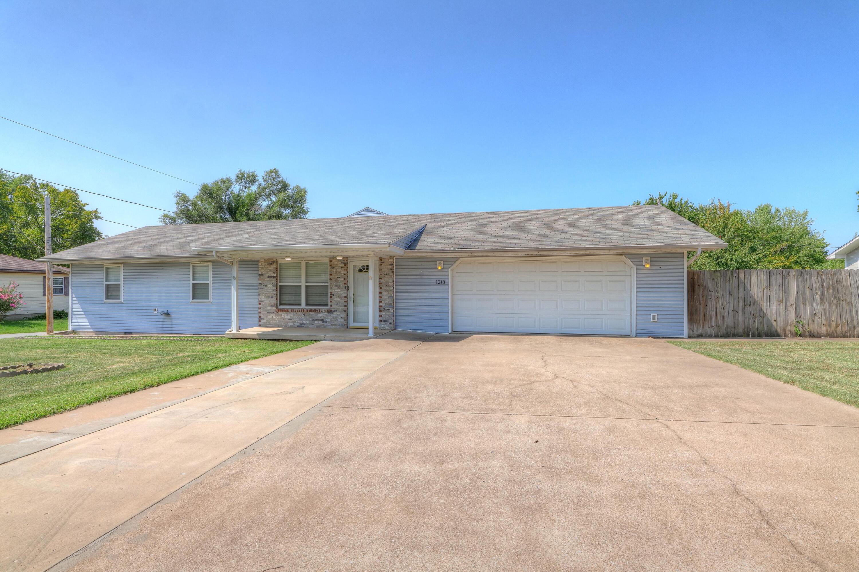Don't miss out on this spacious split floor plan home with hardwood floors throughout- freshly painted interior, new lighting fixtures and fans throughout, granite counter tops-new dishwasher and microwave!! Custom blinds throughout! 2 car attached garage for easy pull in and bringing in the groceries! Wonderful sun room off the back with 2 exterior doors to wrap around deck and ramp! Full privacy fenced yard with chain link garden area and doggie area-30 x 30 shop with 1/2 bath-water and heat!  2 more out buildings with lots of possibilities!! What a deal close to all shopping and highways!! Great location to miss all the hustle and bustle of Rangeline and get where  you need to go!!