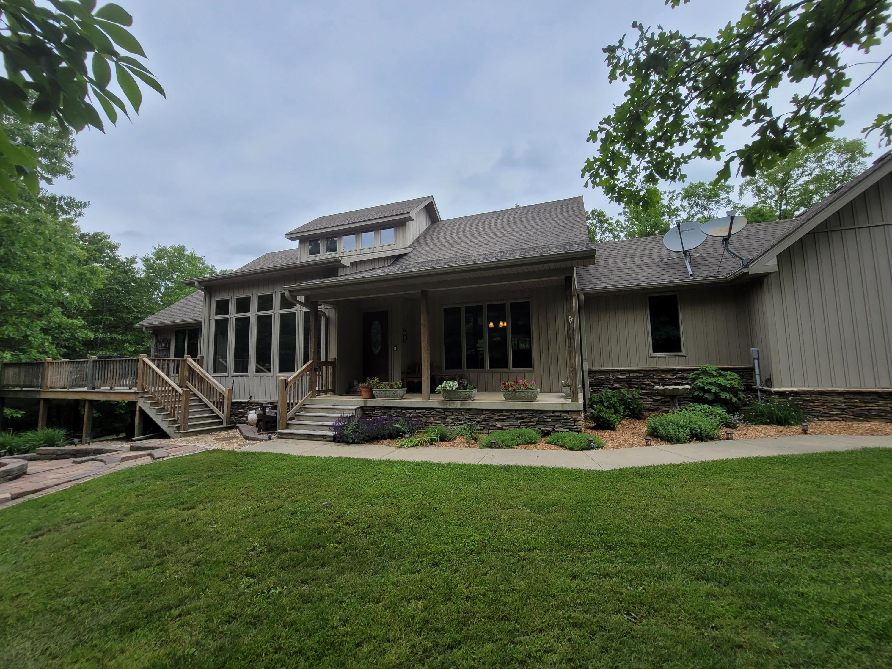Quality and comfort in every turn!  This custom built, well cared for home has so much to offer.  Private wooded setting, hardwood floors, tile, tons of Anderson windows letting in natural light throughout the home.  3 living areas, 2 full kitchens, sunroom, screened in porch, 30x40 detached garage, large dome greenhouse, creek, and almost 2 miles of marked walking, hiking, biking, trails.  This property is impressive and the owners have spent the last 10 years improving it and adding things every year. The home is all electric and averages $175 electric bill with its Geothermal system, 6 inch walls and foam insulation.  They designed to home to maximize sunlight year round and stay connected to the outside. Come see this hard to find gem! You will not be disappointed