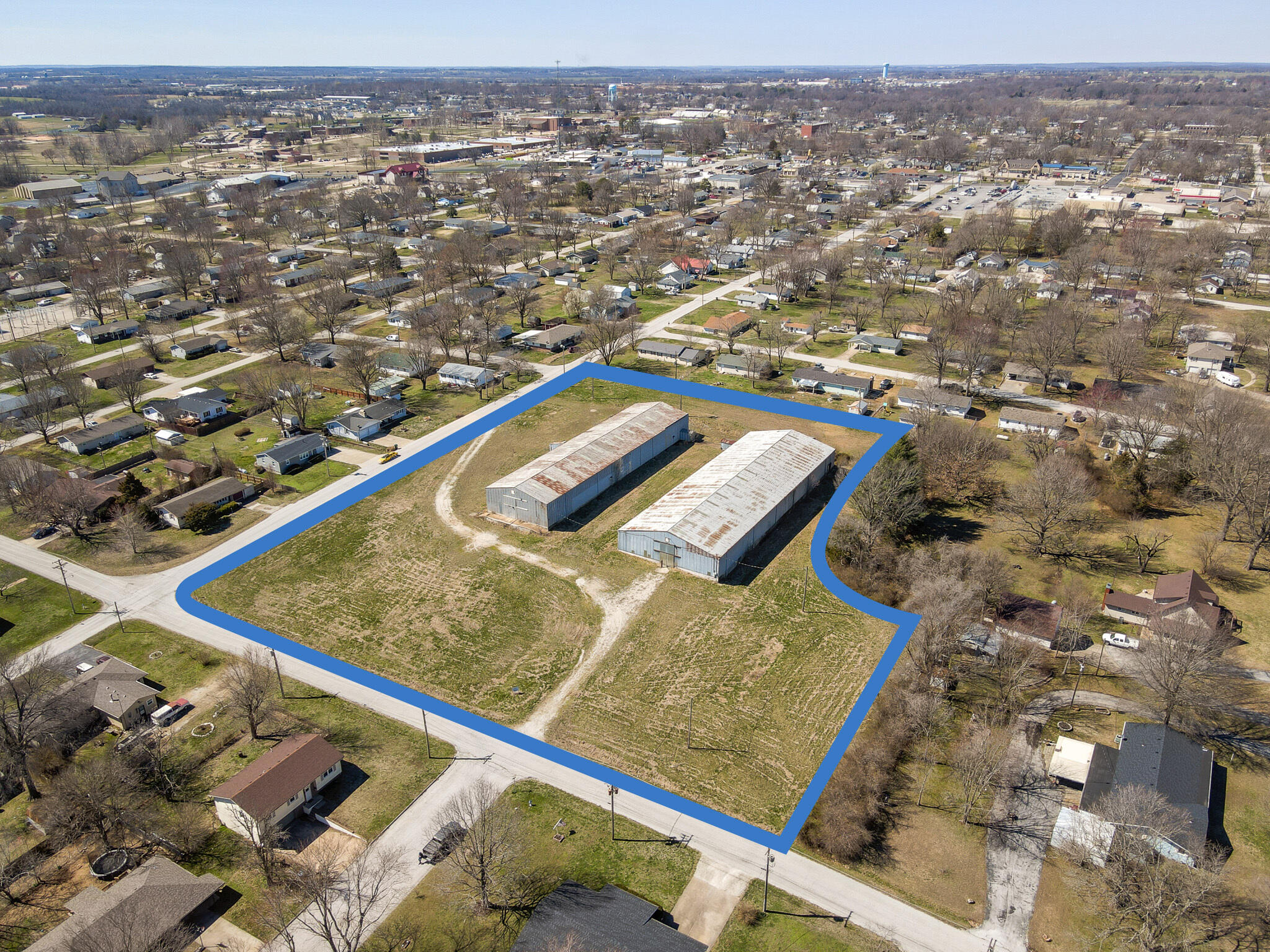 Welcome to Osage Estates - quite the development opportunity to meet Bolivar's need for entry level housing. This 4 acre lot in the heart of Bolivar is within walking distance to any necessity, and can accommodate 12-15 single family residences - current engineering (in final stages of approval with the city of Bolivar) allows for 12 lots. Still on site are 2 large warehouses, 52'x185' and 72'x200' - each is 2 stories and a treasure trove of reclaimable quality materials, much of which is in great shape and could be sold, scrapped, auctioned or used in a multitude of ways.And can't go without saying, if you're an ambitious person who is looking for a lot of indoor and outdoor square footage, consider converting the warehouse into an urban-style living home!Loads of potential and opportunity here, contact your trusted real estate professional for more info.