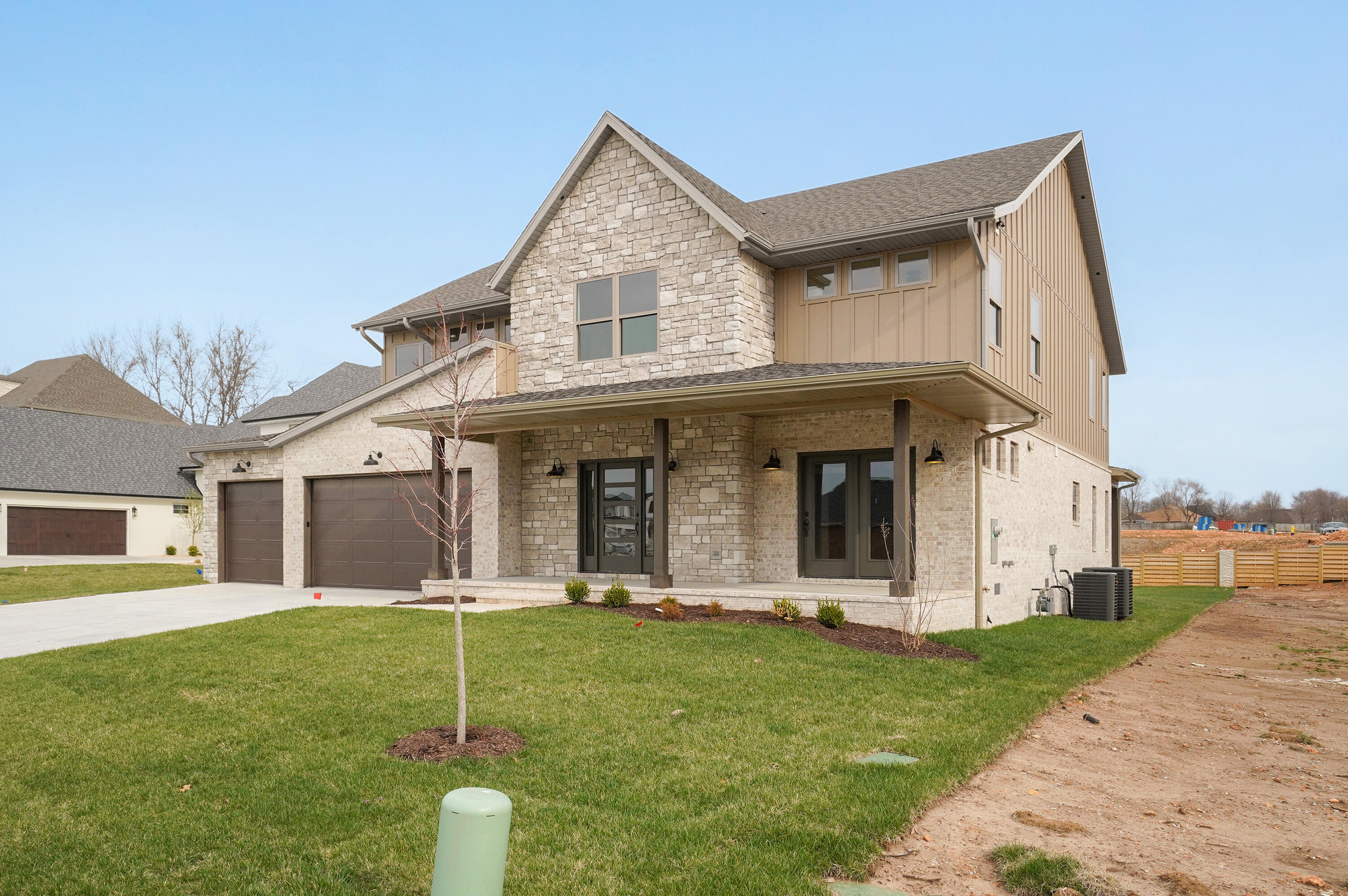 This Modern Farmhouse has a main level master and a guest suite on the upper level. It is located in Anthony Park, a premier subdivision in South Springfield. You'll be impressed from first glance!  From the large front porch, you will enter into the oversized foyer with immediate, breathtaking views through the home.  Designed with an open floor plan, the common area showcases widows in the living space which have ceilings that are two levels high!  Beautiful custom cabinets with lighting, a large island and the must-have farm sink.  The pantry is walk-in and custom designed to include a countertop space. All countertops in the home are granite.  The office is a great work retreat with doors that open onto the front porch.  The master bedroom is perfectly set up as a beautiful, comfortable retreat.  The master bath has custom vanities, a custom walk-in shower and a soaker tub.  The laundry and mud room (with large bench) are on the main level.  The upper level has a spectacular overlook onto the main living area below and a common area.  There are 2 additional bedrooms and the guest suite upstairs.  The guest suite bathroom has an oversized, custom walk-in shower and a soaker tub.  The over-sized closet is built to impress.  The rear of the home is designed with 3 covered, connected patio sections with roof designs that set the home apart.  The yard will have an irrigation system in the front and rear, all sod and landscaping.  The lower-level flooring is luxury vinyl planking, along with the stairway, and the bathrooms upstairs.  The remaining upstairs is carpeted.  The exterior is brick, stone and James Hardie Siding.  This is an above average quality-built home and ready to view. Call today to set your viewing appointment.