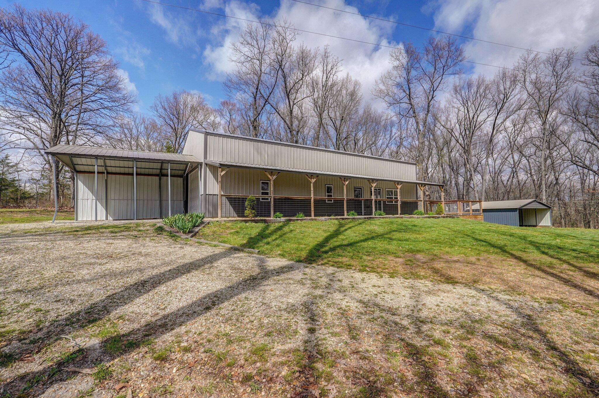 Barndominium goals! This home sits on nearly 10 acres with panoramic views. This 1200 sq foot home has an open layout with spacious living, kitchen and dining space. Dark cabinets, light laminate counter tops and stainless steel appliances provide an inviting space and heated floors are an extra perk on cool days. The bathroom has white cabinets and a walk in shower. The oversized bedroom features vinyl plank flooring and a large walk in closet. Attached is a 1200 sq foot shop with concrete floors and full electric. There is an oversized garage door for enclosed parking as well as a carport for additional covered parking. A large machine shed provides additional storage or parking options. Call for your private tour today.