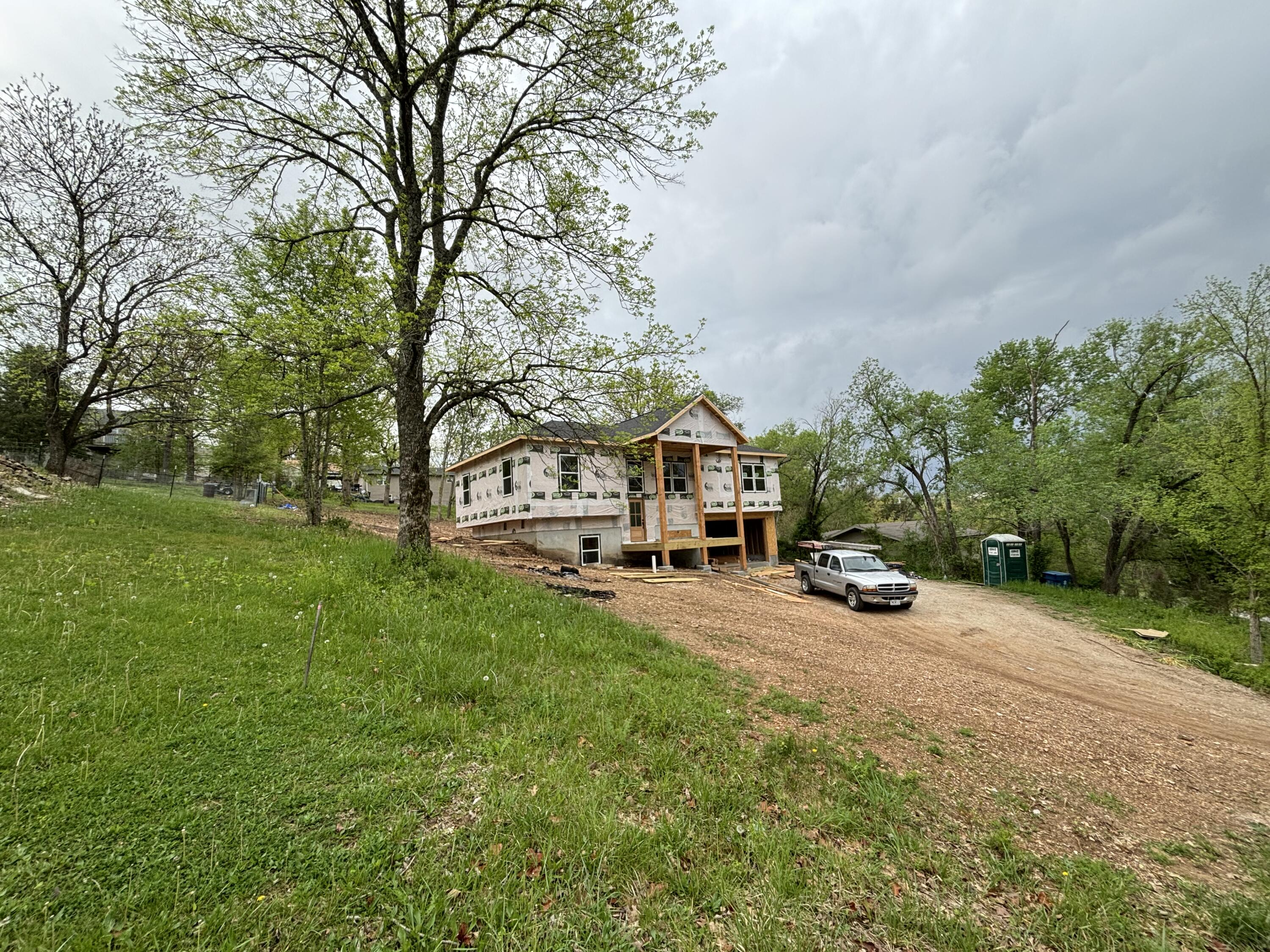 SHOW STOPPER front elevation.  This one will go fast as you will not find one like it on the market.  CHARACTER throughout!  This 4 bedroom 3 bath home has a very grand entrance with the rough sawn cedar timbers as its main entry covered deck.  Then the women will swoon over the WET ROOM.  If you haven't seen a wet room, now is your chance to see it and own it.  It is a tub inside a shower enclosure, so you can shower or tub or both.  VERY HGTV and Pinterest worthy!! This builder does great work at making these SEMI CUSTOM homes stand out amongst all the other listings.  He has high ceilings, wide doors, double garage, granite, and great lighting throughout.  Aside from the wet room, this home has a butlers pantry which is all the rage right now, a huge back deck and very nice sized yard.  Your kids will love this home because they can play in the yard or enjoy the lower level all to themselves as there is a bedroom and family room.COME SEE THIS, WOW home!