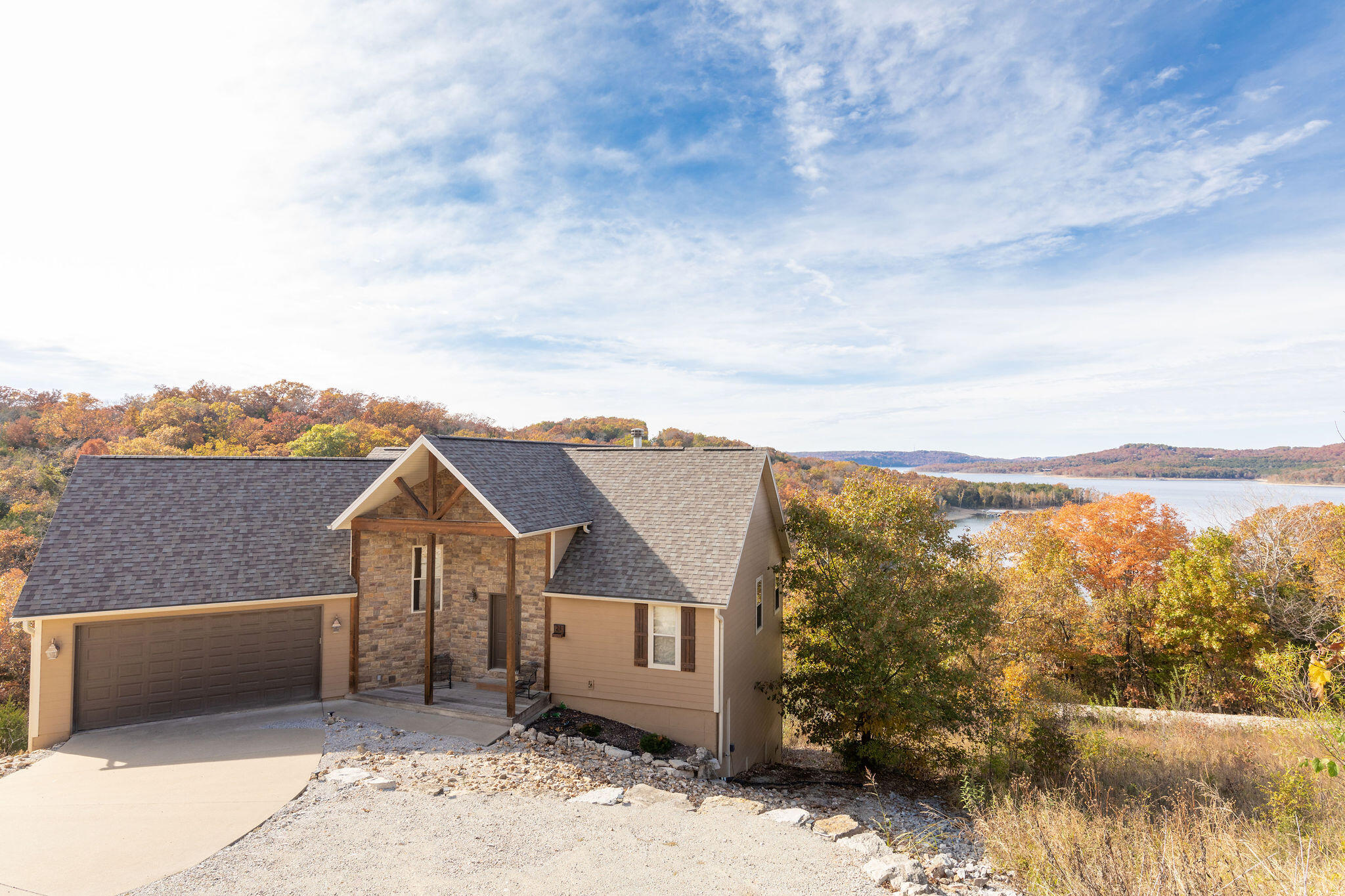Looking for lakefront and BIG lake views? This one has both! Boat slip available too!  This custom built 5 bed 4 bath Lake Home is situated perfectly in the cove but has great main channel views. Walk in to a massive wall of windows showcasing the pristine waters of Table Rock Lake, enjoy the open floor plan, cozy great room with stone fireplace & vaulted beamed ceilings, eat-in kitchen with stainless appliances, lower family room, large deck for entertaining and more! A 10 x 24 slip with lift available for additional $ only a golf cart ride away!