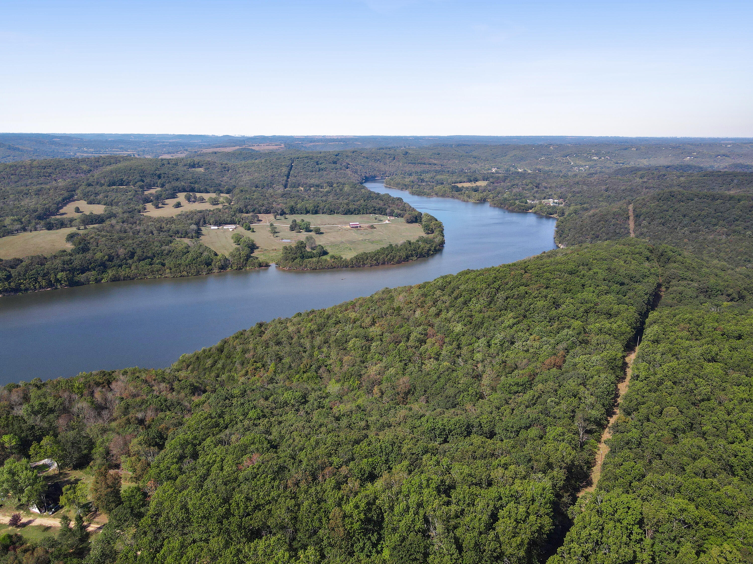 Almost 200 acres of lakefront property is ready for its new owner. Nestled just west of Branson, this land has incredible elevated bluff views over Table Rock Lake with some of the most beautiful scenery and wildlife the region has to offer. Enjoy off-grid living in a cozy cabin or choose from multiple sites to build your secluded dream home and more. Along with two wet weather creeks the property boasts its own cove as well. This is pristine Ozarks forest and lakefront land with everything a nature lover could ever want. Opportunities like this do not come along often, so don't miss your chance to own a piece of paradise.