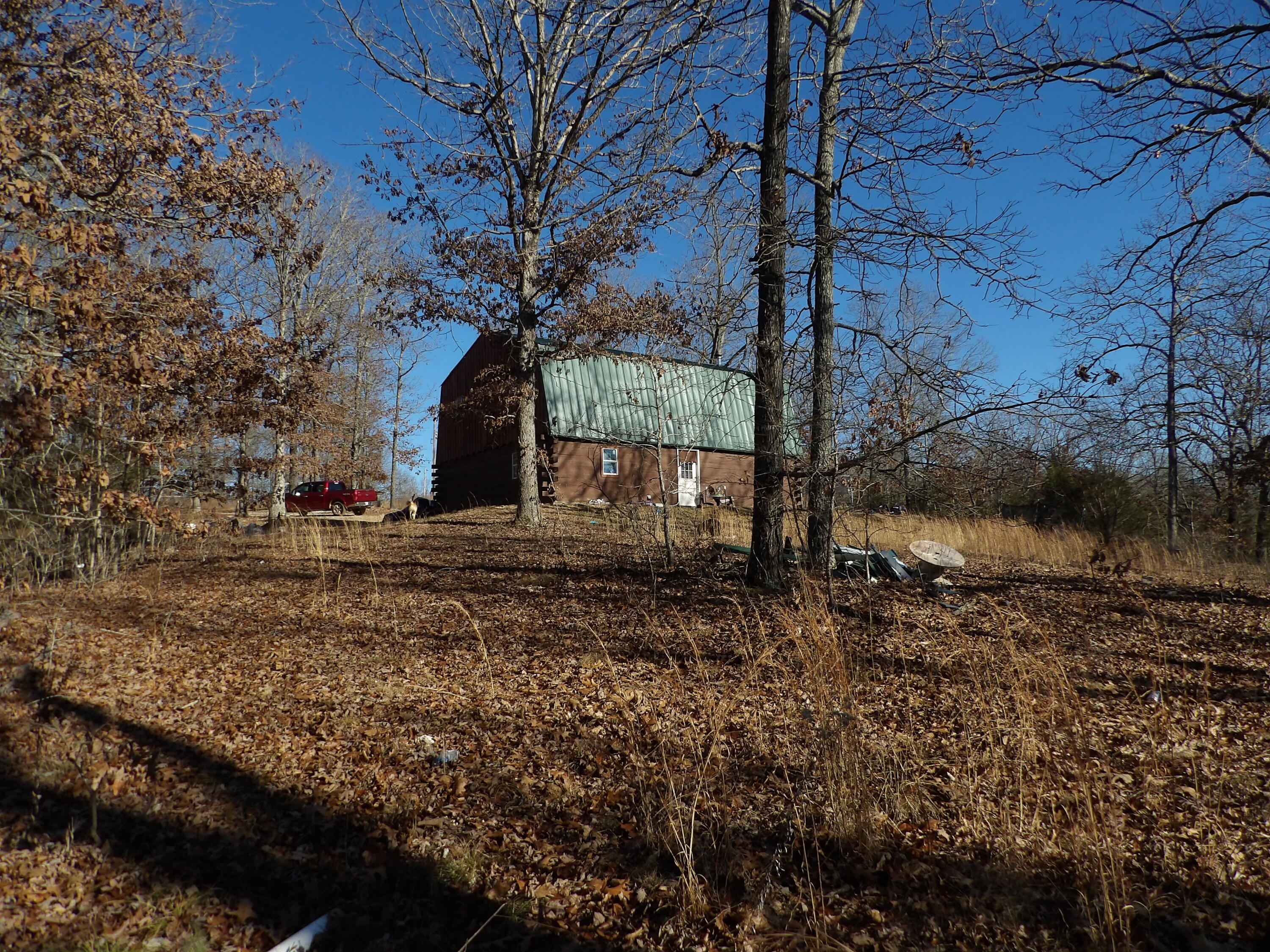 Beautiful Wooded 49 Acres m/l with live water!! This property is located on a Dead End county road, just about 4 miles from the head of the Norfork Lake and features a small spring and a small creek that travels for a ways and then goes underground. The property is teeming with wildlife, for your viewing or hunting pleasure. The two story cabin is only partially finished, so you have a mostly blank canvas, to finish it out, however you prefer. There is also a Conex, for storing your tools and materials, while you are finishing out the cabin. Make an appointment to see all the possibilities, of this property!!