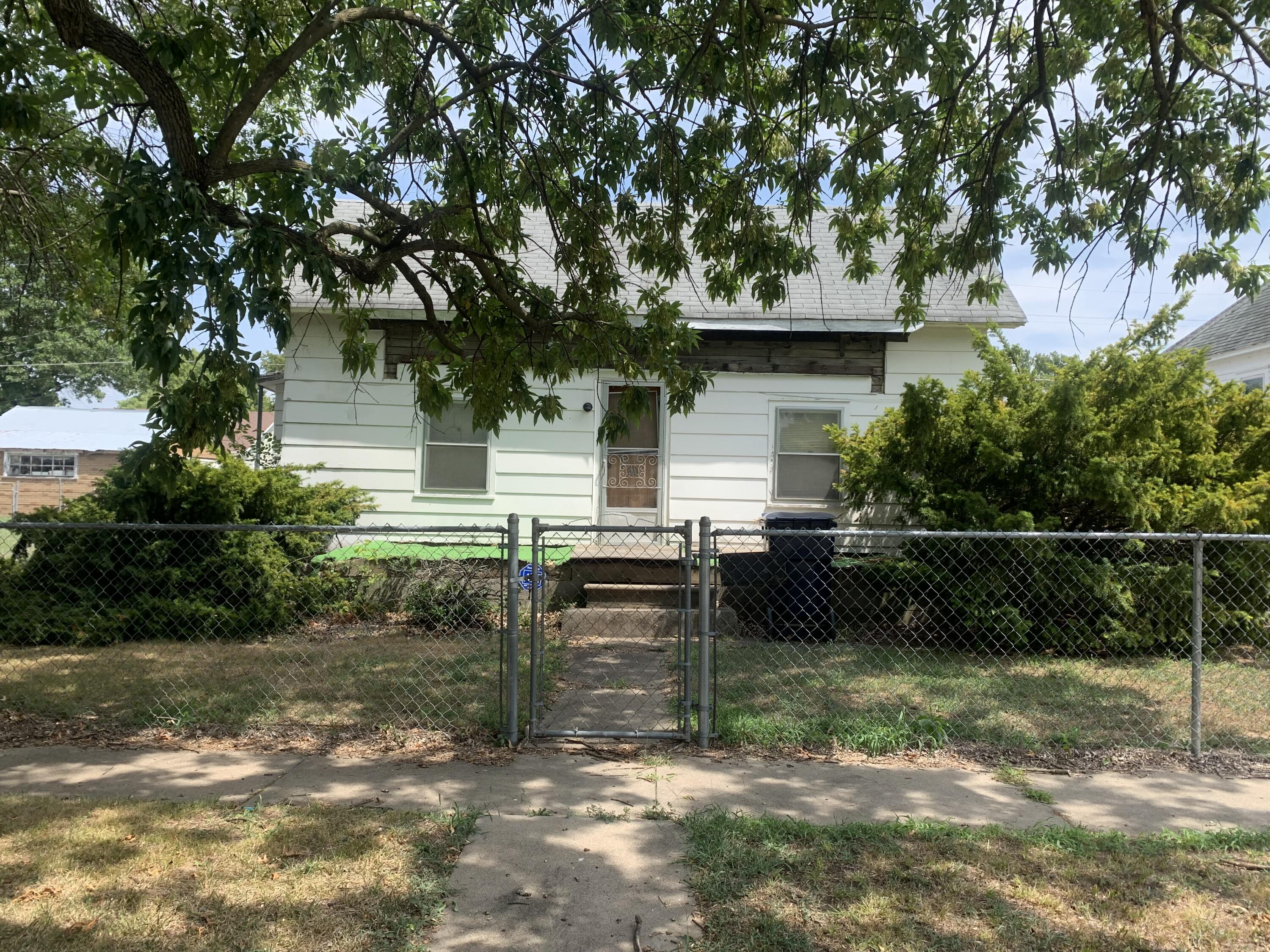 Handyman Special! Beautiful spacious yard with mature trees, chain link fencing and outbuildings. Convenient to schools and downtown Webb City. Selling as-is.