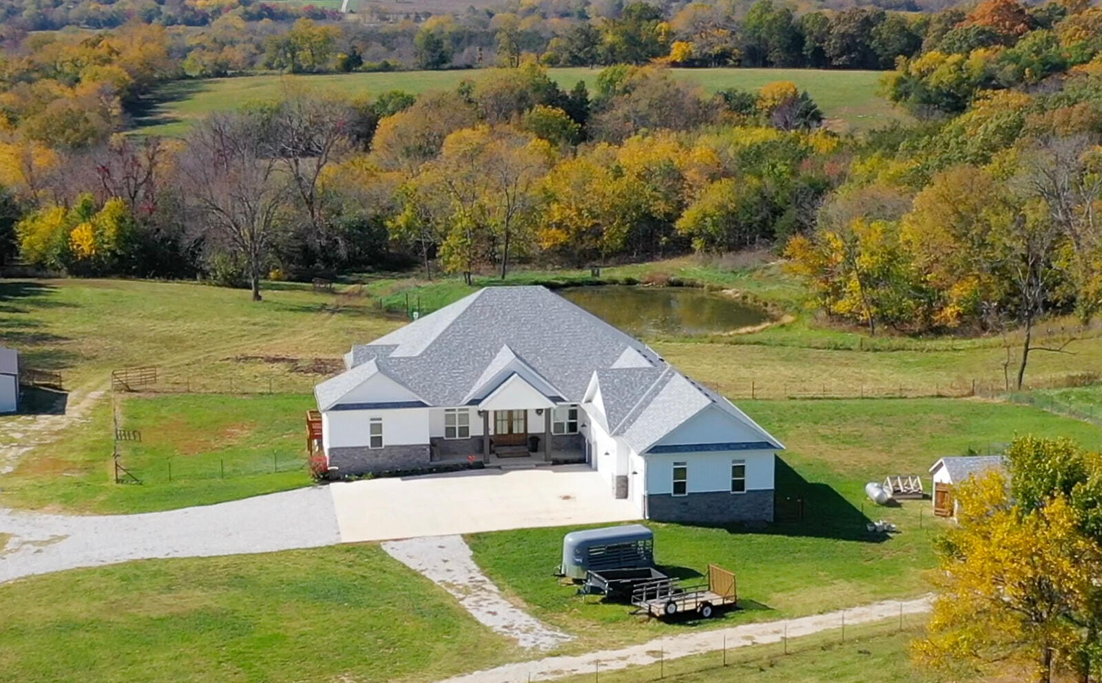 Welcome to your new dream ranch. Turn key ranch property where rural convenience means 2 minutes to small market, 6 minutes to gas station, 10 minutes to Willard, MO. and 20 minutes to Springfield, MO. and all it's amenities. It is a super easy commute. 11/2 yr old 4400 total sf home on 61.5 acres, with around 4000sf liveable space. 4bdrm, 3 full bath plus 4th bdrm can easily be an office and oversized 3 car garage. Master suite and 4th bedroom on first level, two bedrooms downstairs. 10ft ceilings throughout. Stunning 18ft cathedral ceiling entry. Large gas fireplace flanked by lighted bookshelves. 18ft tall glass wall leads to a huge 14'6'' x 70' covered deck, perfect for morning coffee and entertaining. View looks out on spring fed stocked pond. Deck covers a 14'6'' x70' patio. One of a kind chefs kitchen with LG Signature Series 4 burner gas range, 2 induction burners and sous vide on top with double electric oven below. Quartz countertops throughout the house. Custom cabinet front 48 inch Sub Zero fridge/freezer. Large island with drawers and under storage , coffee bar with custom lighted dish display cabinet. Large chefs pantry with counter top, drawers and shelves. Large master bdrm and master bath. Double vanities, oversized shower, slipper tub, toilet room, gentlemans closet and walk-in closet. Laundry room with sink, countertops and cabinets. Lower level includes huge open floor plan that includes living area, dining area and second kitchen with another very large island, electric range, oven, Advantium microwave and fridge/freezer and 2 comfortable size bedrooms and 1 bathroom. Craft room or small office. Concrete steel reinforced tornado shelter with rated door. 2 storage areas, one large, one small. Glass wall of 8ft doors leads to 14'6'' x 70' covered patio. Whole house Kinetico water purification system. 2 zone Central heat and air. Large backyard w/8 - 4x16 raised garden beds and garden shed. Turnkey ranch ready to go. See agent remarks for more.