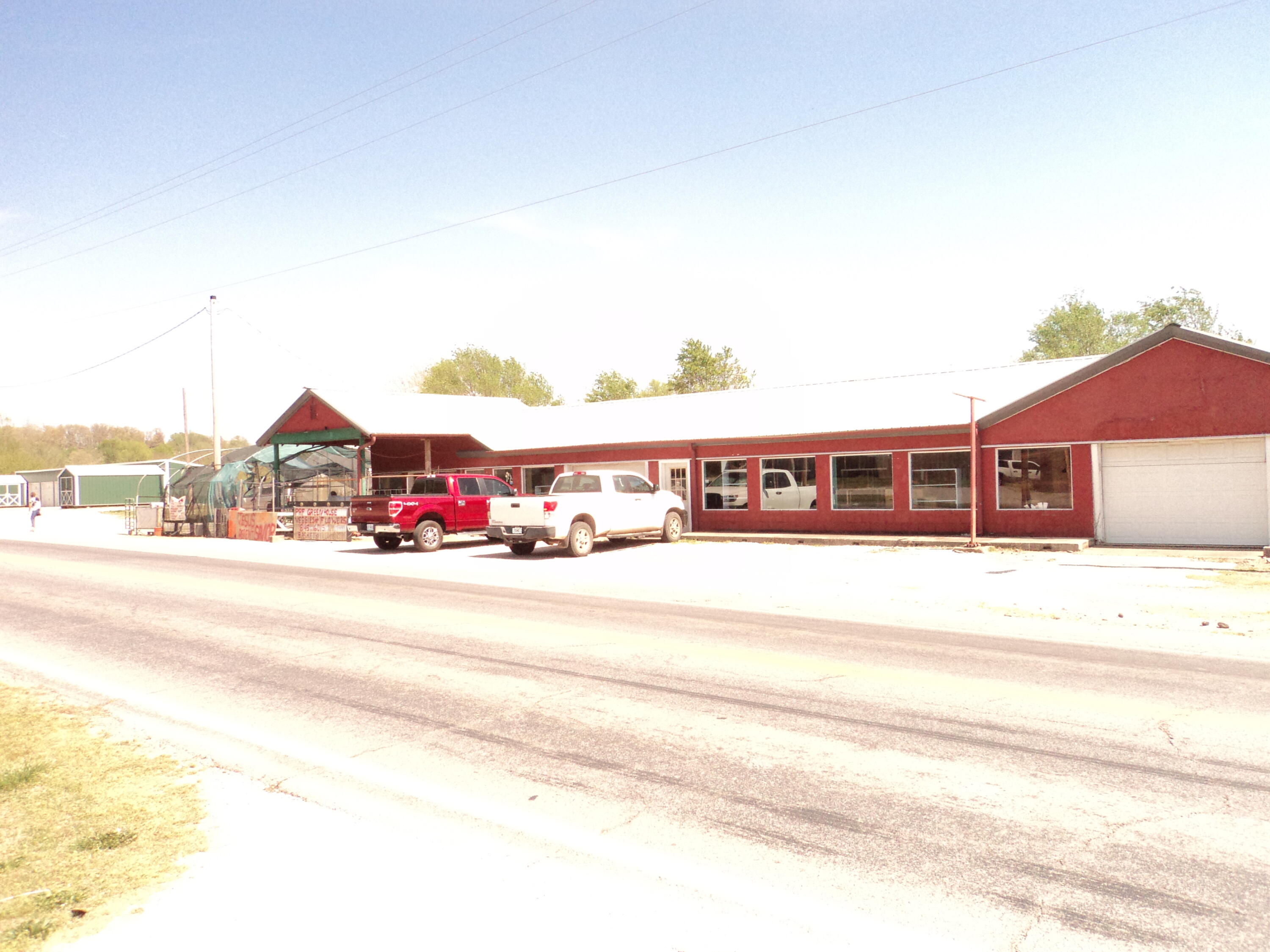 Great commercial property - The possibilities are endless! This property has been used as a grocery store, flea market, green house and flower shop. This property sits on busy Highway 59, which has a very high traffic count. Owner says he will give green house training if you choose that use. This building is over 3200 SF, plus 1450 SF of basement with a loading dock and green houses. 3 Phase power at the pole. Give this one a look!