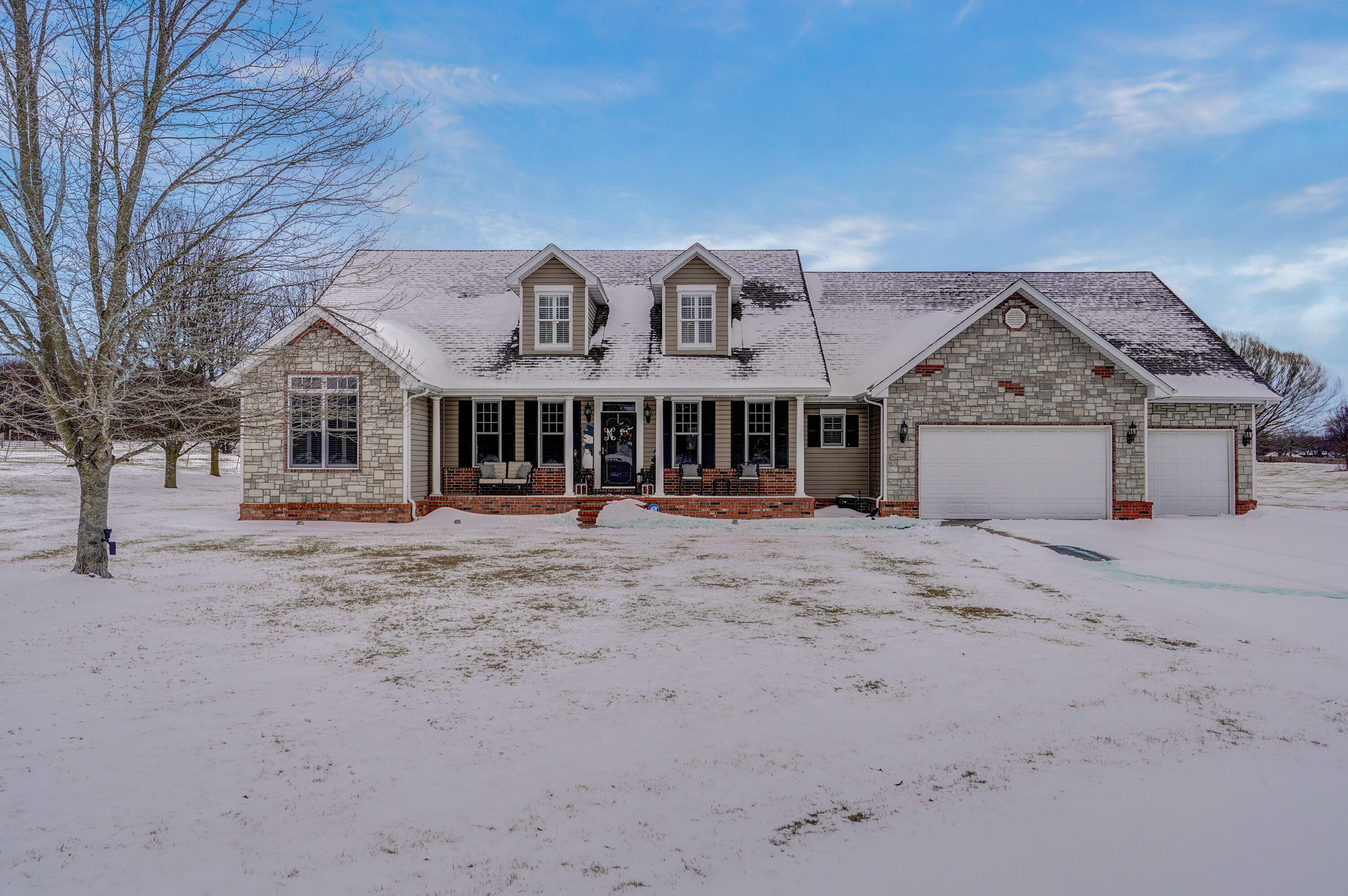 Absolutely stunning property; everything you could possibly want in one of the very best locations in Nixa! This one is fantastic all-around! The attention to detail in the design and recent remodel are simply perfect. The main level has a kitchen any host would love! Not one inch was lost in this carefully curated space. The cabinet storage is immense, beautifully crafted and efficient. Plenty of additional pantry storage is directly off of the kitchen. A spacious living room adjoins the kitchen and formal dining area, making it the perfect spot to relax and enjoy the big game! Stunning new hardwoods throughout the main level! Master suite is off of the kitchen, along with an additional two bedrooms (split floor plan), one of those recently expanded to include a sit-in media/living area. An additional two guest bathrooms are on the main level, along with mudroom and access to one of the nicest sunroom/outdoor living space areas you will come across; enjoy every season in the exceptional comfort that has been crafted for you! Upstairs features an excellent media/recreation room, additional oversized full bath with one bedroom attached and another adjacent bedroom at the end of the hall. The garage is not your ordinary garage space. Featuring deep bays, storm shelter, MyQ remote system, and workshop, this has it all! Love to enjoy time outside?... this is your place! The views are perfect on nearly 3.5 manicured acres. It's truly a backyard oasis with market lighting, expanded covered deck area and a perfectly constructed fire pit that will make memories for years to come! It's amazing to be so close to so much and still feel like you are far out, enjoying the serenity of the country. Really can't say enough about this one. It's special from top to bottom and has been lovingly cared for by an exceptional family. Please make sure you have this on your list; you won't be disappointed!