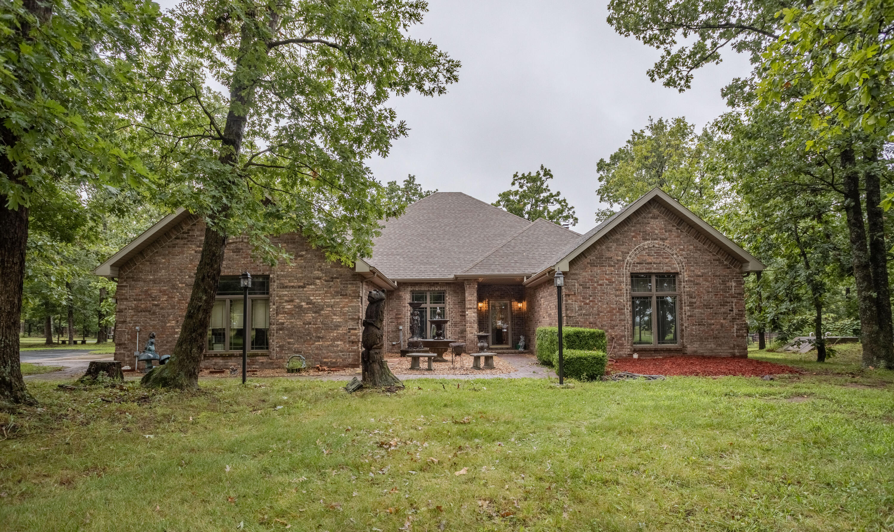 Discover the epitome of country living with this extraordinary 48.5-acre estate, boasting immaculate landscapes, horse facilities, and a stunning mixture of pasture and wooded acres. Fully fenced and cross fenced, you can't miss the equestrian excellence embodied in the meticulously designed pipe fencing and corrals, ensuring great safety and comfort for your equine companions. Enjoy the extensive 2-mile network of riding trails throughout the timber and pasture. Additional land features include 3 ponds, a spring fed creek, and an abundance of deer and turkey. Nestled within this stunning landscape is a custom-built brick home that radiates timeless elegance. The home boasts 2,618 square feet of living space, with four spacious bedrooms (one currently an office) and two bathrooms. Custom cabinets, a custom wood beam fireplace, granite counter tops, and slate tile are just a few of the luxurious interior features. Adjacent to the main residence, a versatile 60x80 multipurpose building awaits. Equipped with five thoughtfully designed horse stalls, ample shop space, and an additional 720 sqft living space, this building can accommodate all of your pastime activities. Located off State Hwy 39 and just north of Miller, MO, you can experience the pinnacle of country estate living, while only 10 miles from Mount Vernon, MO and 35 miles to Springfield, MO. Every detail of this property has been carefully orchestrated to offer the ultimate rural living experience.