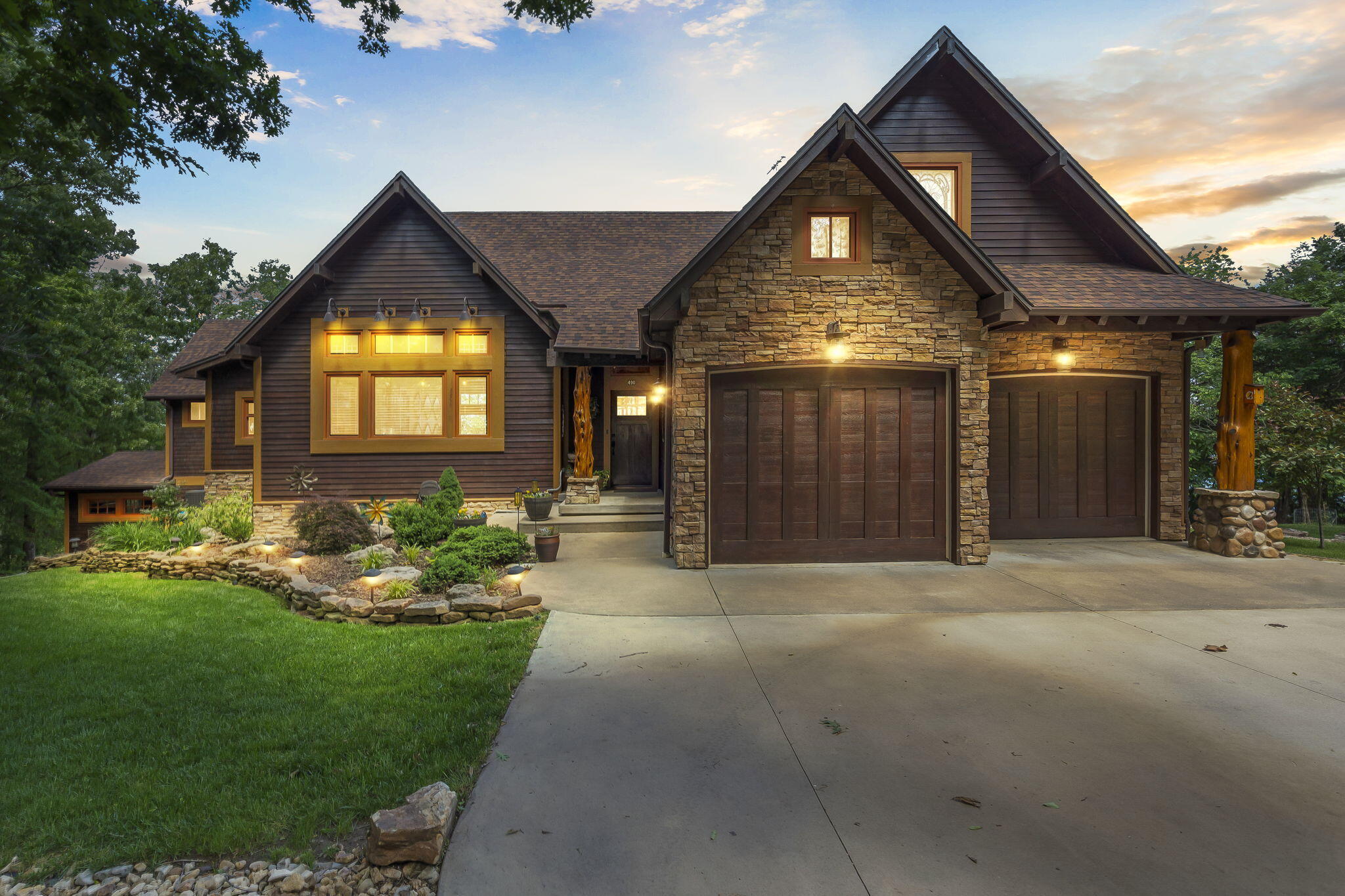 Truly one of the best lakefront lots on Table Rock Lake.  No expense was spared on this one of a kind craftsman style lakefront home. From the moment you pull in the drive you are in awe of this stunning home and the beautiful landscaping.  The main floor has an open kitchen, dining, and living area. This area is well planned with a 7 ft long Sugar Pine wooden island acquired from Yosemite National Park, custom cabinetry , quartz countertops, a commercial grade gas stove with griddle, drink station with bar sink, built in beverage refrigerator, ice maker, and Napoleon wood burning fireplace insert. Also on the main level is a laundry room/butlers pantry, primary bedroom with full bath, another bedroom with a built in Murphy bed, and a full guest bath. Off the living area is a a screened in patio that is just dreamy.  The patio itself is 750 sq ft complete with a wood burning fireplace and incredible lake views. Downstairs has another family room, 2 bedrooms, and a full bath.  Two adorable bunk rooms.  One with 2 twin beds and the other with built in bunk beds. There is a large heated workshop that could easily be converted to another bedroom or a whatever you want room. There is also a room that is currently used for storage that could also be converted to a 4th bathroom.   To top it all off there is a gentle meandering walking path to the lake!  There is a two car oversized garage on main level with an epoxy floor and a single oversized garage on the lower level.  Parking was also a consideration in the design of the home and there is ample parking for 10 vehicles. There is also a 30 amp hookup outside the downstairs garage and a 50 amp hook up off the lower deck. Furniture and decor also available to purchase. Crystal Beach is a beautiful neighborhood with a community clubhouse and swimming pool.  10x24 boat slip with lift for an additional $65K. The community boat docks are protected in a cove and have  possibly the most gentle walkdown on the lake.