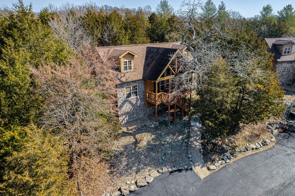 Just in time for Spring/Summer 2023!! Beautifully furnished & decorated 4bdr/4ba cedar & stone lodge with successful rental history. KING beds and added bunk beds to sleep 13!! NEW upstairs dual HVAC systems; NEW full size W&D 2021; NEW stainless appliances 2019; NEW interior paint & professionally cleaned carpets. Hardwood floors throughout living areas; gas fireplace; screened deck + unique added decking for additional outdoor entertaining. Stonebridge amenities include gated entry, multiple pools, tennis courts, Clubhouse with restaurant/bar, exercise room, plus renowned Ledgestone Golf Course. Owners can self-manage as a STR or use as a personal full time residence.