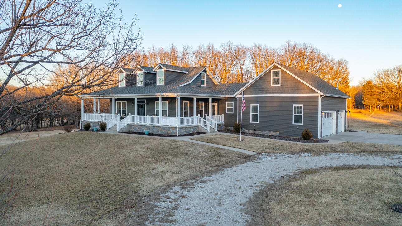 If you are looking for your forever home and a place to enjoy country lifestyle, look no further than this beautiful custom one owner home. It sets on 13 peaceful acres overlooking a creek and wooded area that is much like having your own private park.    With a wraparound porch, you can find a place to sit and enjoy the views along with a cup of coffee almost anytime of the year.  There is a covered patio that would be the perfect location for your own personal hot tub.  This home has many custom features that really make it unique.   Some features include a large kitchen area on the main floor with stainless steel appliances which include a double convection oven, warming draw and even a lifter for your mixer that stows in the cabinet when not being used.  There is a large island with a gas cook top and stainless-steel hood and still plenty of room for people to gather around for dining and entertainment. On the main floor you will also find the master bedroom/bathroom.  There are two closets located in the master along with a large bathroom that has a jetted tub, walk in shower and two vanities.  A large pantry along with the laundry/mud room are located on the main floor as well.  There is a formal living area and a nice sunroom located just off the kitchen that has a beautiful, vaulted ceiling.     Upstairs on the second floor would be a great place for another bedroom or recreation room.  You will find a full bathroom on this level.  The second floor includes a walk-in closet along with multiply storage areas.   The walkout basement is finished with a full kitchen.  The basement has a large bedroom, full bathroom, living area, and second laundry hookups.   This spacious walkout basement would be an ideal second living area.  A large 3 car garage would be a great place to set up a workshop area and still have plenty of parking room for your vehicles.  The garage is heated and cooled so you would be able to work out there any time of year.