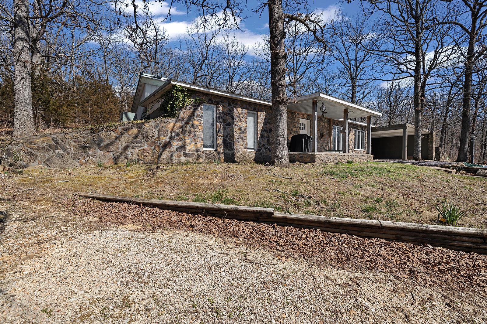 Such a unique property!! This berm house is located on 5.5 secluded acres!! This home features 2 bedrooms and an office. Semi open concept in the main area with lots of natural light. The kitchen features granite counter tops and plenty of cabinet and counter space. Down the hall you will find the spacious master bedroom with a walk-in coset. You will also find an additional bedroom and a full bathroom. Beautiful, secluded setting with mature trees. The property includes a storage shed and a big shop that will fit an RV. The shop is equipped with electricity, water, sewage, concrete floors and a camper hook- up. Located in the Marshfield school district, with quick, convenient access to the overpass. Schedule your showing today and fall in love with you new home!