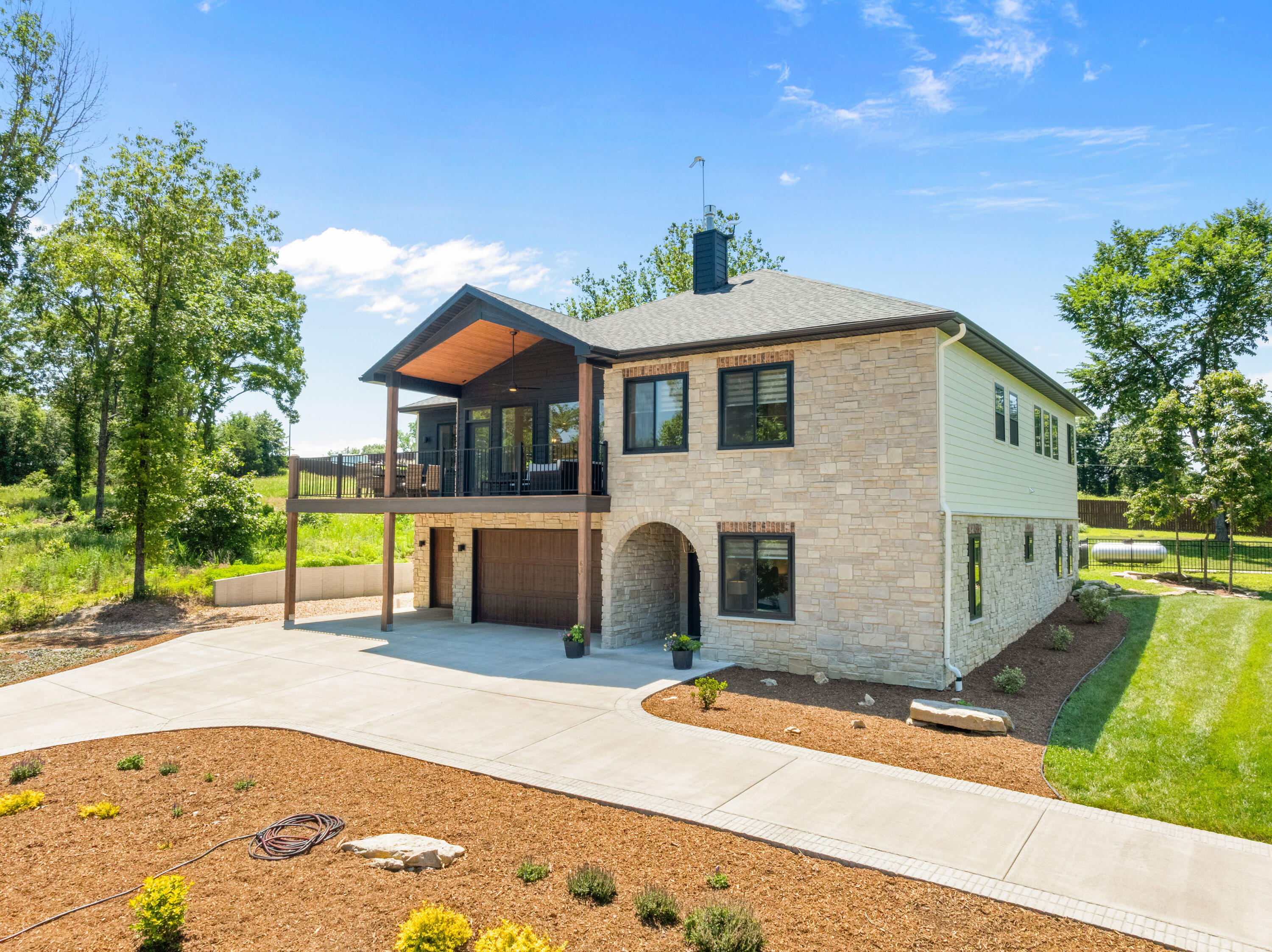 Executive Lakeview Home with 28 foot boat slip available for additional $$.  This 3700+ sq feet, 4 bedroom, 3 bath residence features stone arched entryway into well appointed foyer.  Adjacent to foyer is entrance to 3 car garage with 60 amp svc for electric car charging, guest suite, full bath and 600+ sq feet of storage area.  Upstairs you will find a spacious open living area consisting of great room with gas fireplace, dining, kitchen with 10 foot island and built in banquette.  Off the kitchen is a butler's pantry with additional dishwasher and refrigerator.  Front and rear covered and open porches/decks provide extraordinary lake view entertaining and relaxation areas.  Primary bedroom suite and ensuite features include large walk-in shower, built -in stack washer/dryer and laundry supply area, convenient to walk in closet with built in cabinets/shelving, etc.  Two additional guest bedrooms and full bath complete the main level living.  This home was built to a higher standard:  2 x 6 exterior and interior walls, exterior with Centurion stone and DiamondKote siding, Anderson black composite dual pane windows, engineered wide plank hardwood floors, 10' ceilings on main level, fenced back yard, Bosch appliances, quartz and granite countertops, wiring for internet and circular drive with professional landscaping.  This home exemplifies quality and superior design.  Additional Lot # 56, adjacent to home, is available for purchase.