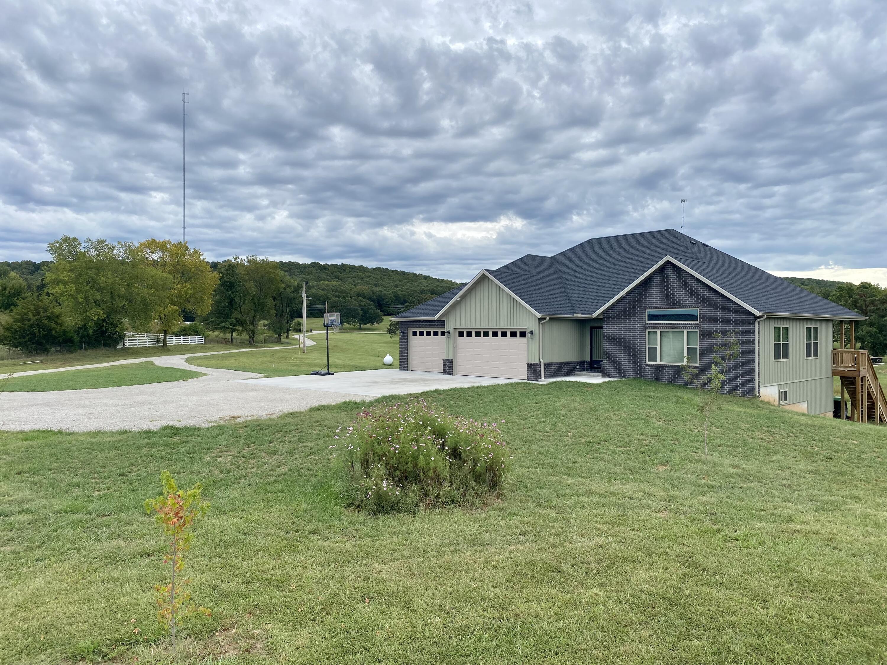 LOOK at this builders custom built walk out basement home on 6 acres!!  It comes with a heated attached 3 car garage with 8 ft tall garage doors, the basement has a 25 ft deep garage perfect for a boat and also a 30X24 detached 3 car garage with 8ft 9in tall garage doors.  So many upgraded features in the home including luxury vinyl plank flooring throughout, open floor plan with cathedral ceiling, kitchen with island, convection oven with an air fryer, quartz countertops and soft close drawers.  The master suite has a side porch plus a large walk in shower.  The home has city water with a water softener plus zoned heat and air.  It also has a safe room.  Don't let this showplace pass you by!