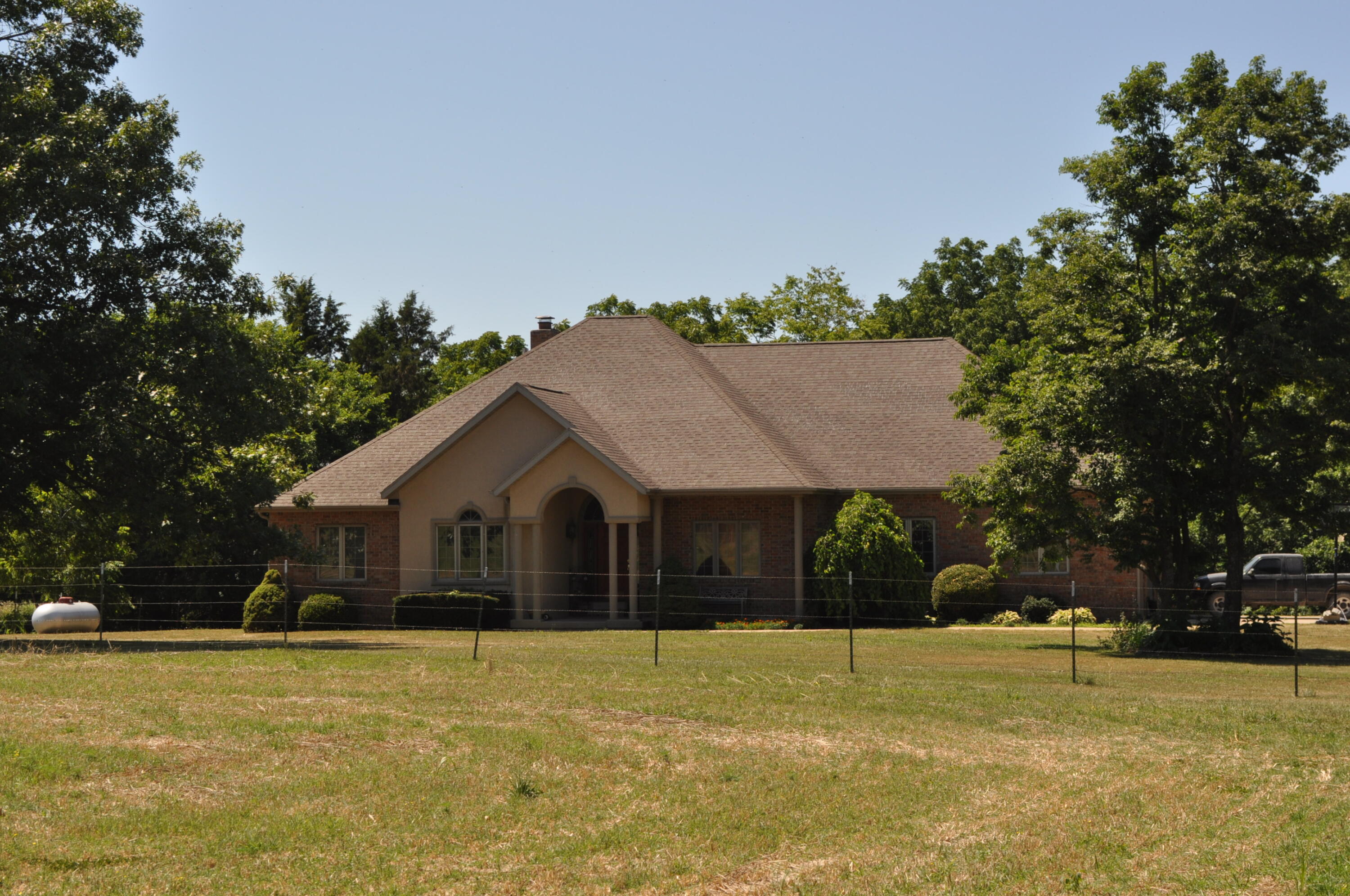 This wonderful home and 75+/- acres is located East of Springfield and just minutes north of Hwy 60 and Fordland.    The over 4000 square foot all brick walk-out basement home is nestled back off the road with trees on 2 sides. the layout of the land is optimized with mostly all tillable land for feed production and the remainder in pasture and cattle space.  The property has a pond and well for ample water.  The pasture traps have concrete line bunks and feeders.