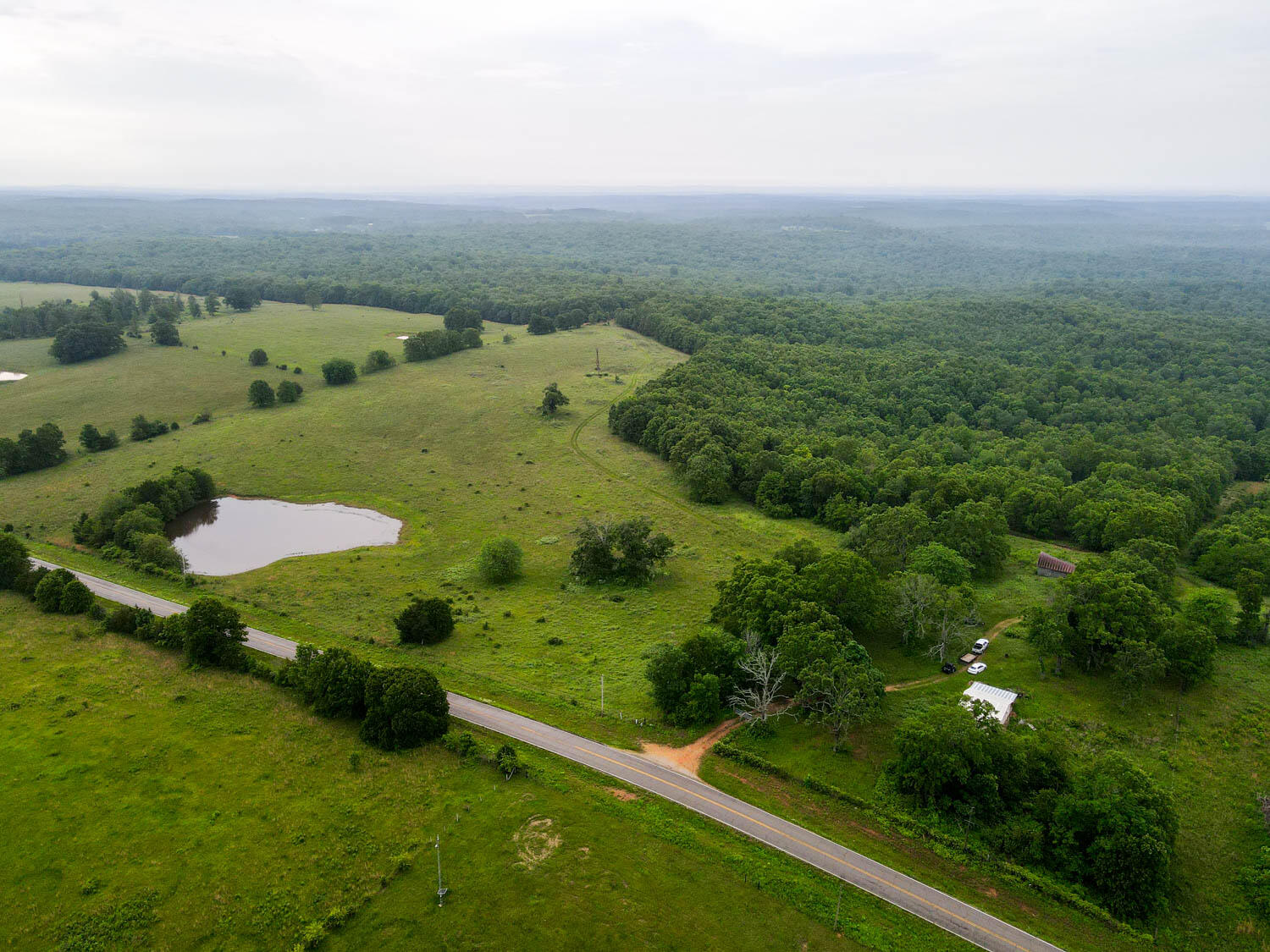 Explore this 1,207+/- acre hunting haven nestled in the Missouri Ozarks, offering nearly two full sections of pristine landscape. Spanning across 1,207+/- acres of rolling hills, this property is a hunter's paradise. With 200+/- acres dedicated to pasture and several food plots scattered throughout, the land is not only a sanctuary for wildlife but also presents an opportunity for livestock endeavors. The property boasts numerous ponds, the vibrant Ragan Spring, and a wet weather creek, ensuring ample water sources for both wildlife and livestock. Whether you're an avid hunting enthusiast or someone who prefers the exploration of nature's marvels, this ranch offers endless opportunity and beautiful winding trails. Close proximity to the Eleven Point River and the expansive Mark Twain National Forest opens up a world of additional recreational possibilities. On-site, a cabin awaits restoration, offering a potential hunting retreat in the wilderness. This property is not just a hunting or recreational ground; it's an opportunity to establish a connection with the Ozarks' natural beauty. With opportunities for further development into a comprehensive livestock operation, the potential of this land is as vast as its vistas. Offered at an exceptional value of less than $2,250 per acre, seize the opportunity to own a piece of the Ozarks' majesty.