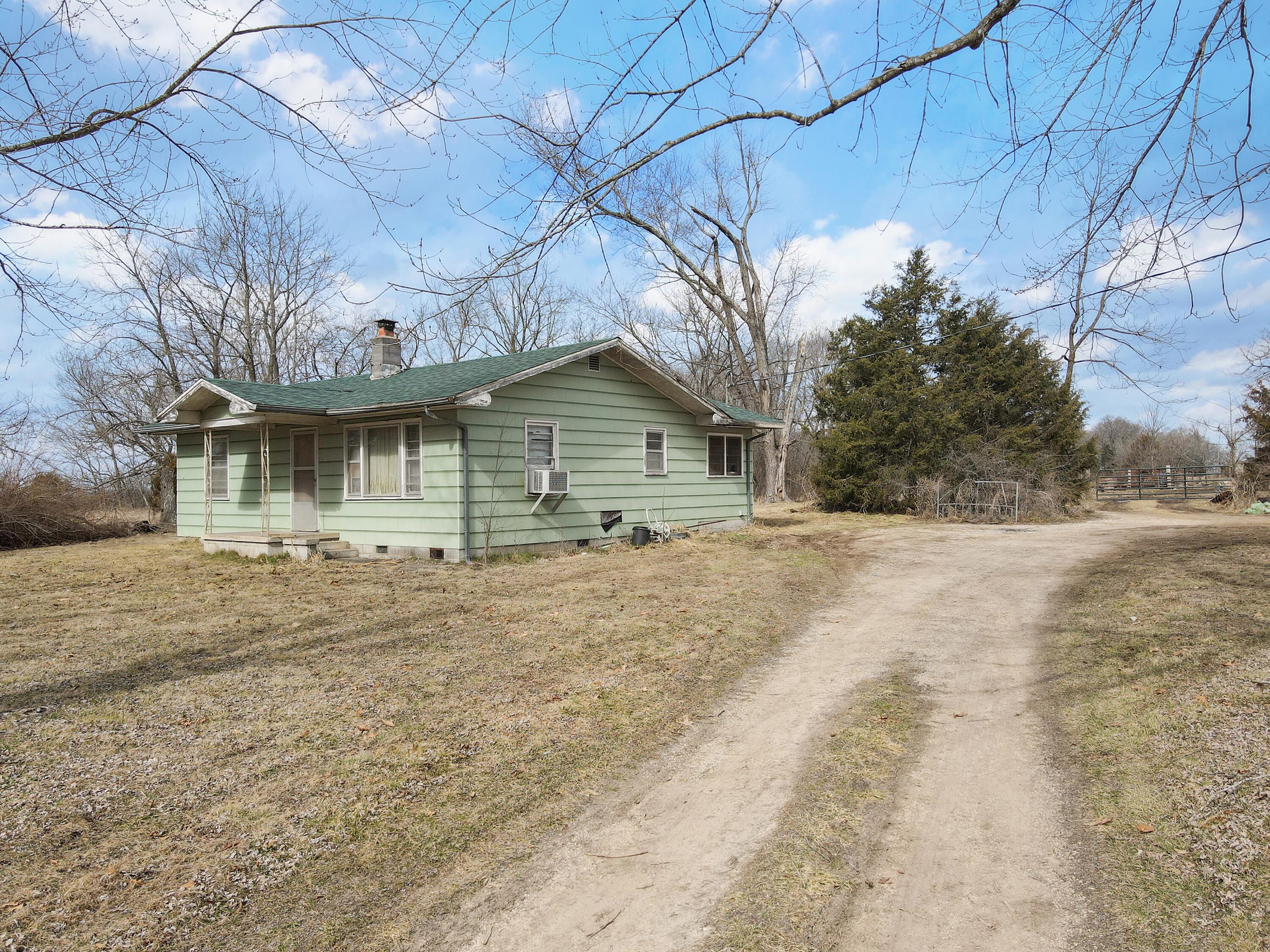 Talk about hard to find 115 acres mostly flat with some trees.  It approximately 5 miles to Wal-mart, Lowes or 15 minutes to Springfield,  and about 20 minutes to Branson.  Easy access to Hwy 65 to go wherever you want.  No value to the house.  No access to the home.  40 X 80 concrete floor, insulted red steel shop. 1 well and concrete septic tank.  Over a mile of road frontage Prairie Ridge and Moon Valley.   Listed as 2 parcels.  Call with any questions.