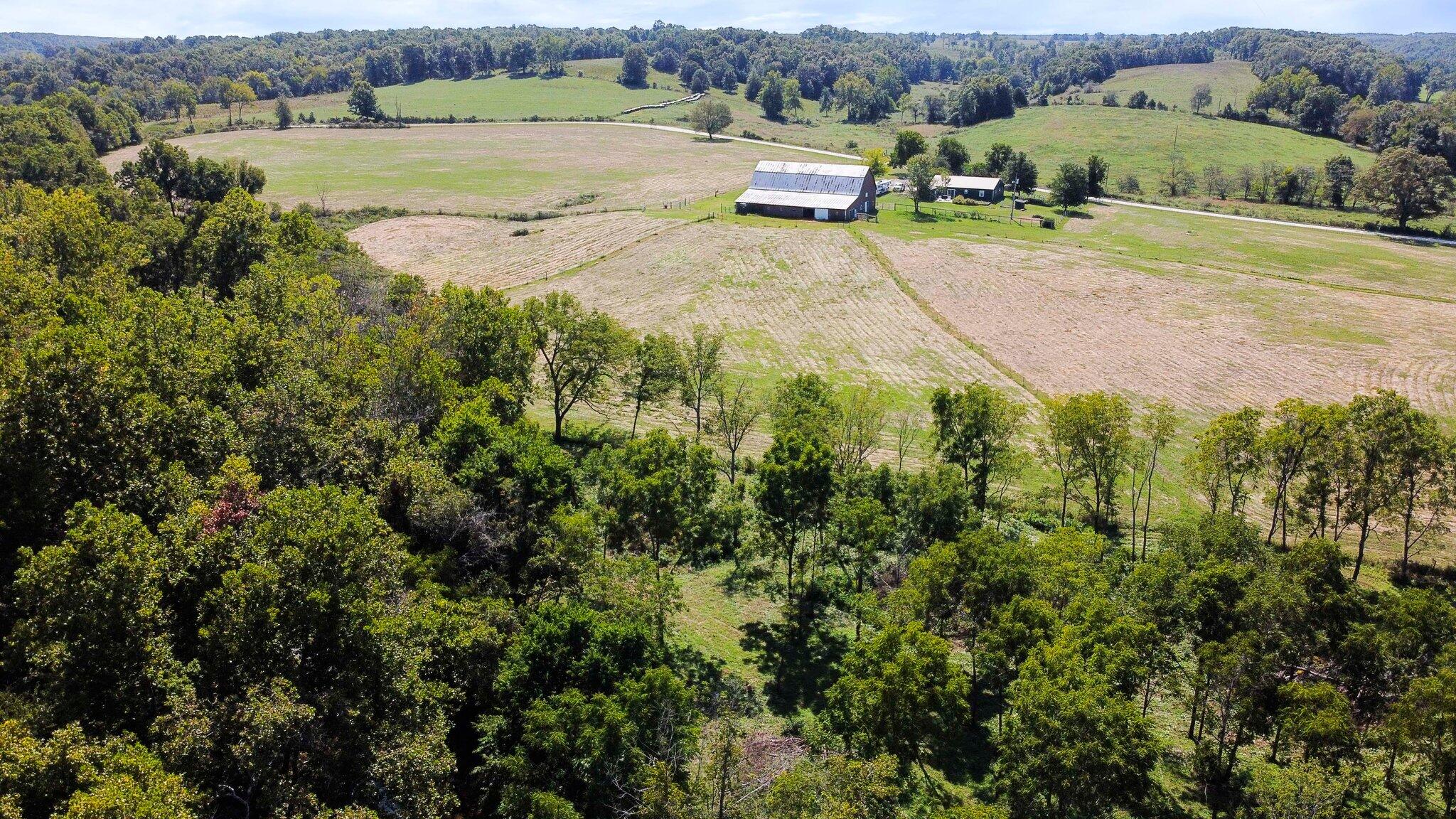 If you are looking for the perfect farm only 30 minutes from Springfield, Missouri then welcome to Wrangler Ridge Horse Farm.  This beautiful 92 acre farm has 1/4 mile of Finley Creek running through it.  The 3 bedroom 2 bath ranch style rustic home has an open floor concept that makes entertaining easy. The kitchen has hickory cabinets and an antique style cook stove. The home is energy efficient with metal siding and a metal roof.  Outside you will find 2 established garden spots, blackberry bushes, apple trees and a beautiful manicured yard.  There is approximately 40 acres of hay/pasture all fenced and crossed-fenced with live water of Finley creek running through the property. There are some beautiful manicured trails  throughout the property, with nice outcroppings of rocks and an additional flat spot ready for a camper or another residence. The 65x85 barn is set up for horses with 11 stalls, tack room and a hay/storage area electric and water as well as an additional hay loft.Lastly there is an old dairy barn that has been converted into a workshop and storage area.  Great property for a horse/cattle operation, horse motel or training facility. Hunt, fish, grow crops and livestock to live off the land. Move in ready and a must see property.