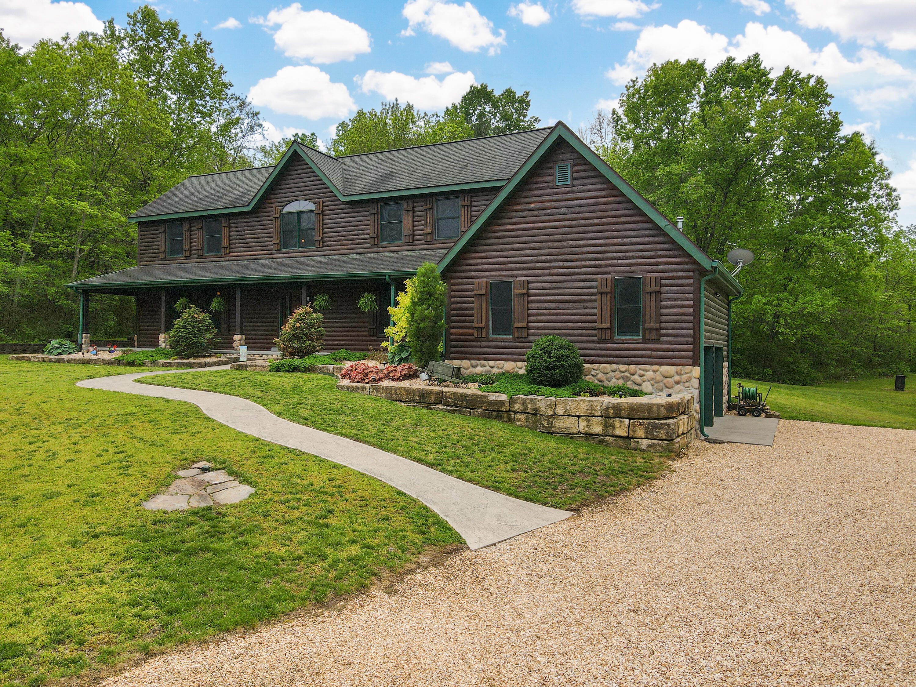 Welcome to your own private slice of Heaven, includes your log sided house, 56.73 ACRES fully fenced property! With 3,278 sqft, 5 bedrooms, 3 bathrooms, 2 car attached garage plus a large custom shop; with tandem garage doors- drive through for your travel trailers! The stream and spring-fed pond are gorgeous. There are FOUR water faucets for outdoor watering access. Wonderful feature of 2 tankless water heaters for quick hot water. Owners are leaving all the furniture; breakfast table, living room set, bedroom set, dining room set, lamps, grandfather clock and book case upstairs, (except the computer desk)!! The house has soaring ceilings with stone fireplace and formal dining that welcomes you! You will love the kitchen with granite counters, wonderful hickory cabinets, induction cooktop, double ovens, and walk-in pantry. The primary suite is on the main level, generously sized! The primary bathroom with jetted tub, double sinks, and large closet is wonderful! The laundry room is off kitchen and garage area. The large screened -in porch is so relaxing for your morning routine or evening or weekend relaxing time! Updates are; Roof tear off and replace 2013 All appliances 2013New water softener 2022Exterior log siding re-stained 2021Home has separate heat pump and furnace for 1st and 2nd floors ,1st floor heat pump and furnace replacement 2014, Home has a Generac 20Kw ,fully automatic generator with its own 500 gallon propane tank.The parcels; there is a 54.73 and a 2.0 size which equals 56.73 acres.