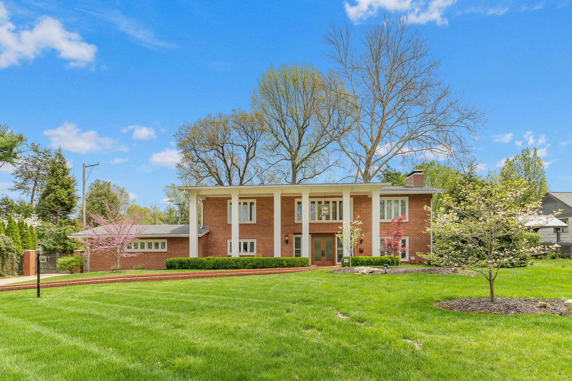 Situated in Phelps Grove, this all brick two story traditional home is a real gem. With 4 bedrooms and 3 baths, it was custom built in 1957, remodeled in 2014 and more updating in the past couple of years. The main level features a grand entry way with a curved staircase and gleaming tile flooring, a large living room with gas fireplace, a sunroom with brick paver flooring, a formal dining room, bedroom or office, full bath with shower, and a gourmet kitchen.  The kitchen features Thermador stainless steel appliances which consist of a separate freezer and refrigerator, double ovens, microwave and 6 burner gas stove with warming tray.  A huge island, granite counters and abundance of windows are some other kitchen features. Beautiful hardwood flooring is on both levels of the home. In back of the home is also a screened in porch and a lovely landscaped privacy fenced yard. Upstairs are three spacious bedrooms including the master and two full baths.  There is also an unfinished basement which is great for storage or could be finished out.  It has a wood burning fireplace there as well.  The garage entrance is at the rear of the home and includes a large parking space. To go to the back of the home an electric gate provides security.  Other special features of the home include zoned HVAC system, surround sound system, central vacuum, inground sprinklers and plantation shutters.