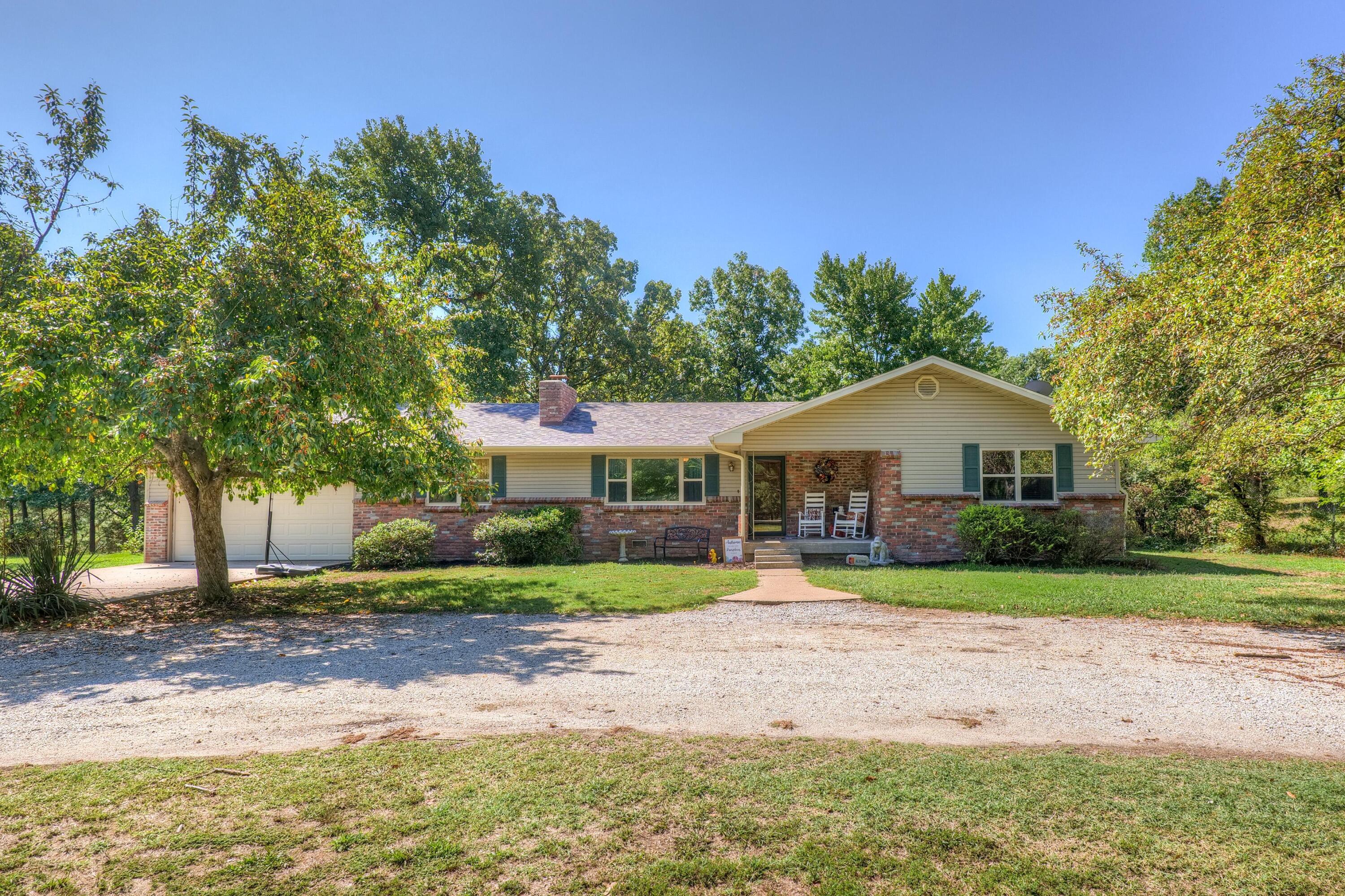 Well maintained 3 bed/2bath one level home just outside city limits in Southwest Joplin!  Sitting on almost 2 acres, this home features a NEW roof in 2021, multiple living areas, circle driveway, pool, and hot tub!  From the covered front porch, enter into the living room with a wood burning see-through fireplace and wood floors that extend to all the bedrooms.  Kitchen features stainless appliances, ample cabinet space, an island AND bar for extra seating/storage, and space for a dining table. Off the kitchen is an additional family room with built-ins, laundry room, and bonus space!  Primary bedroom suite features a walk-in tiled shower and vanity with extra counter space.  There are two more bedrooms and the 2nd full bathroom.  The backyard is the perfect entertaining space with a wooden deck, patio with hot tub, and 20' above ground pool!  Quick access to I-44 and Hwy 43. Seneca Schools. Call to schedule your tour today!