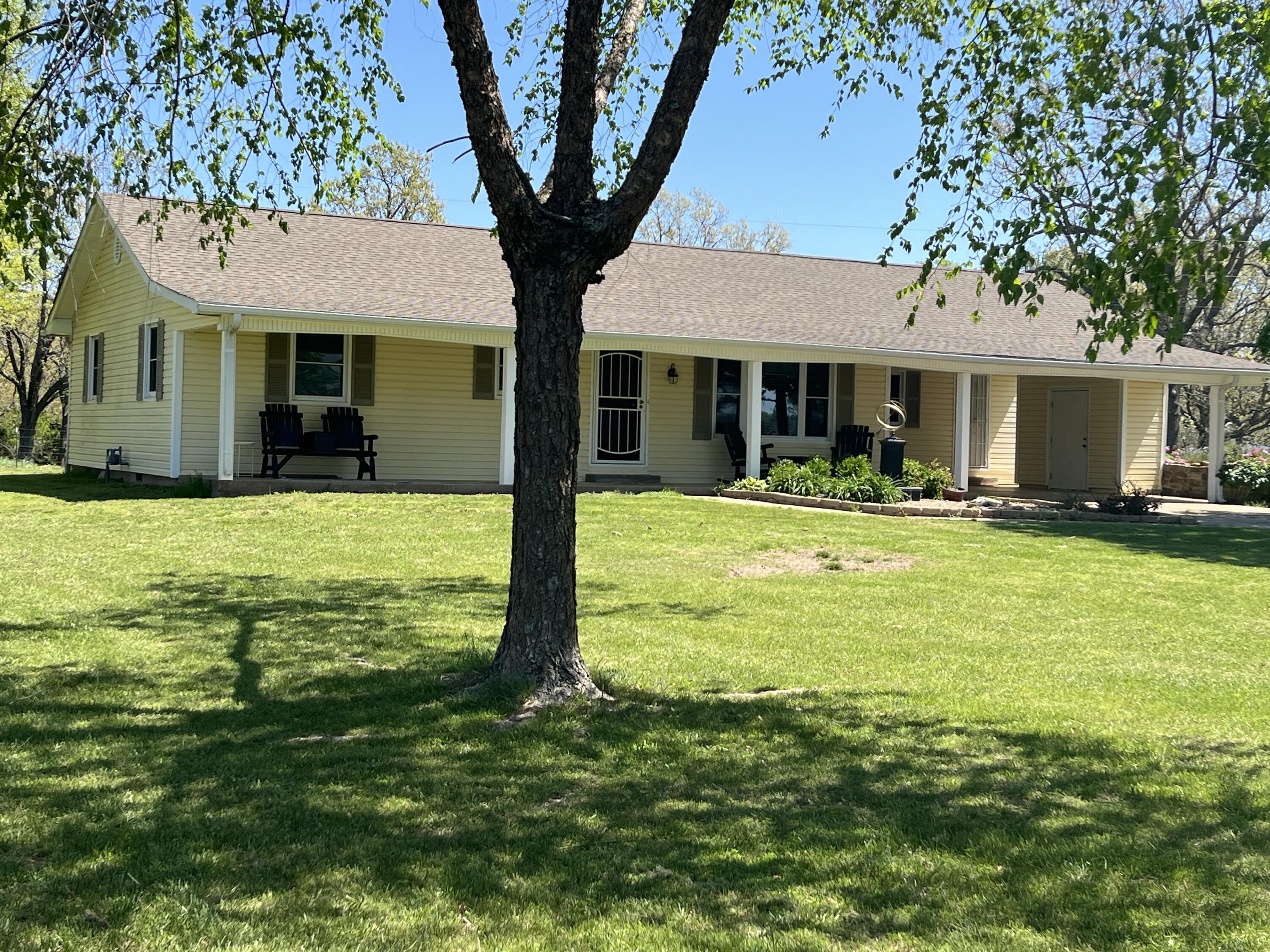 Beautiful home at the edge of Cassville with rolling 20 acres m/l, 2 large shop buildings, landscaping and yard is gorgeous with raised rock flower beds, Gated entry with lit driveway, paved circle , covered front porch, newer hvac system  All of this is just the outside! Inside this luscious home you are met with a spacious open floor plan, original hardwood floors under the carpet, newer kitchen cabinetry, luxurious tile walk in shower, and tons of other updates.  3rd bedroom is non-conforming with no closet. If you aren't in need of the 3rd bedroom it would make a great closed in porch with tons of windows and views to die for!