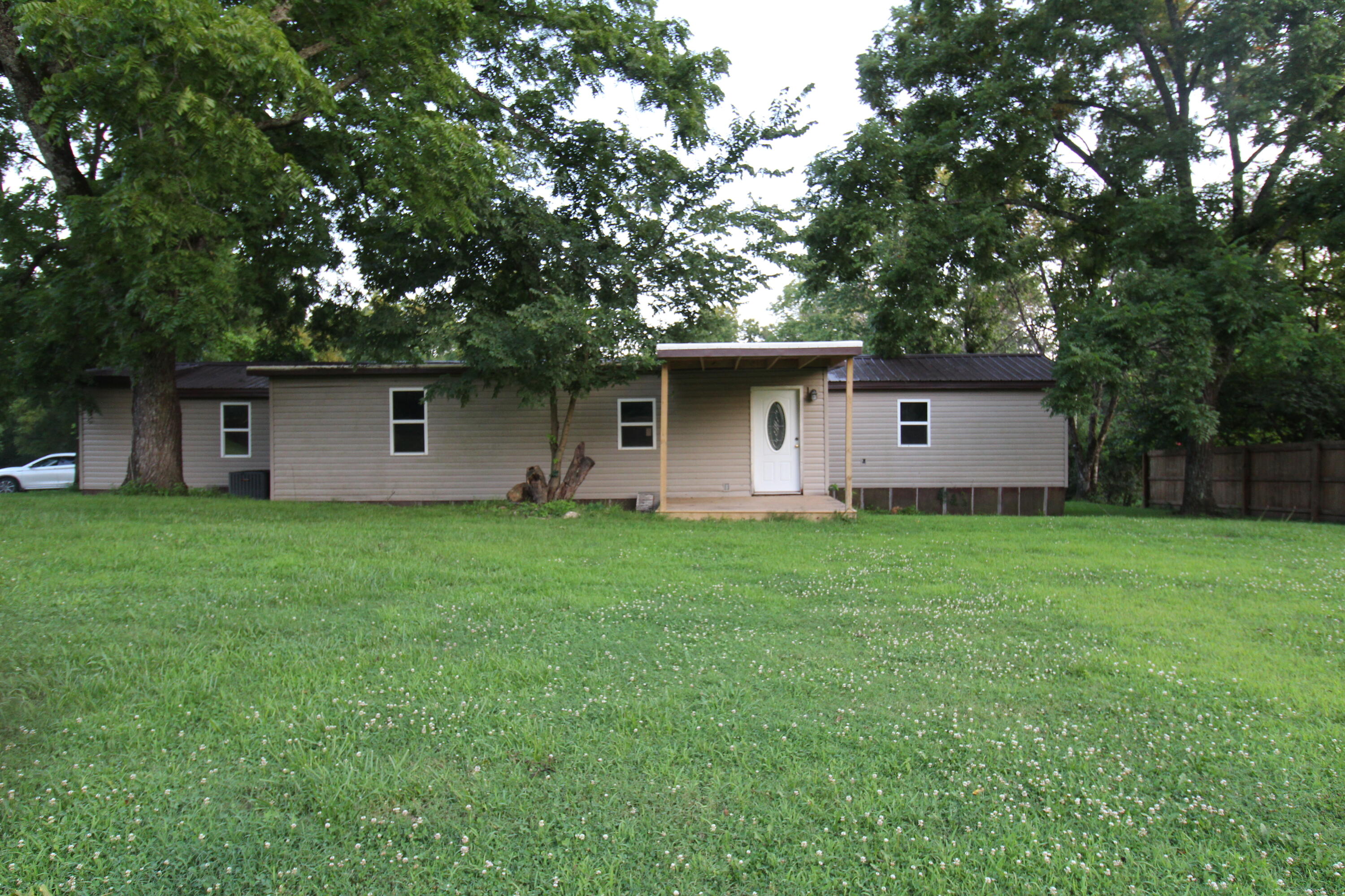 Park like setting with privacy on 2.6 acres of usable land. 5 bedrooms including 2 master suites and a total of 3 bathrooms. Privacy fence surrounds the yard. There's also a 2 stall tractor shed w/ tac room 25 x 30. This 1985 Clayton mfg. home has been secured with 6x6 treated posts that are anchored down along with concrete blocks that are tied down. Outside improvements include, Metal roof, double pane windows, landscaping. Inside improvements - kitchen cabinets, flooring, big sink, countertops, the additional bedrooms & bathroom. New tubs, toilets, fixtures. New HVAC system, new sheet rock in some areas. A bargain!